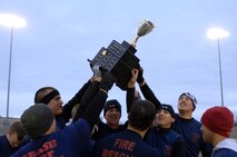 GRAND FORKS AIR FORCE BASE, N.D. – 5th Civil Engineer Squadron firefighters raise the championship cup high overhead after winning the first-ever Dakota Bowl Championship flag football game here Nov. 15. The 5th CES Fire Dawgs won the game 27-21 in overtime. The idea of the Dakota Bowl/Cup came from the sports directors at both bases. They wanted to get the best teams in each intramural sport to have a one-game playoff to decide the best in North Dakota. (U.S. Air Force photo by Senior Airman Kelly Timney)