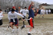 GRAND FORKS AIR FORCE BASE, N.D. – Tech. Sgt. Tom Anderson,  5th Civil Engineer Squadron firefighter , rushes past the Grand Forks AFB defensive line to avoid being sacked during the first ever Dakota Bowl Championship flag football game here Nov. 15. The 5th CES Fire Dawgs won the game 27-21 in overtime. The idea of the Dakota Bowl/Cup came from the sports directors at both bases. They wanted to get the best teams in each intramural sport to have a one-game playoff to decide the best in North Dakota. (U.S. Air Force photo by Senior Airman Kelly Timney) 