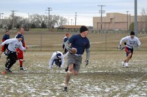 GRAND FORKS AIR FORCE BASE, N.D. – Senior Airman Daniel Payne, 5th Civil Engineer Squadron firefighter, runs the ball downfield  during the first ever Dakota Bowl Championship flag football game here Nov. 15. The 5th CES Fire Dawgs won the game 27-21 in overtime. The idea of the Dakota Bowl/Cup came from the sports directors at both bases. They wanted to get the best teams in each intramural sport to have a one-game playoff to decide the best in North Dakota. (U.S. Air Force photo by Senior Airman Kelly Timney)