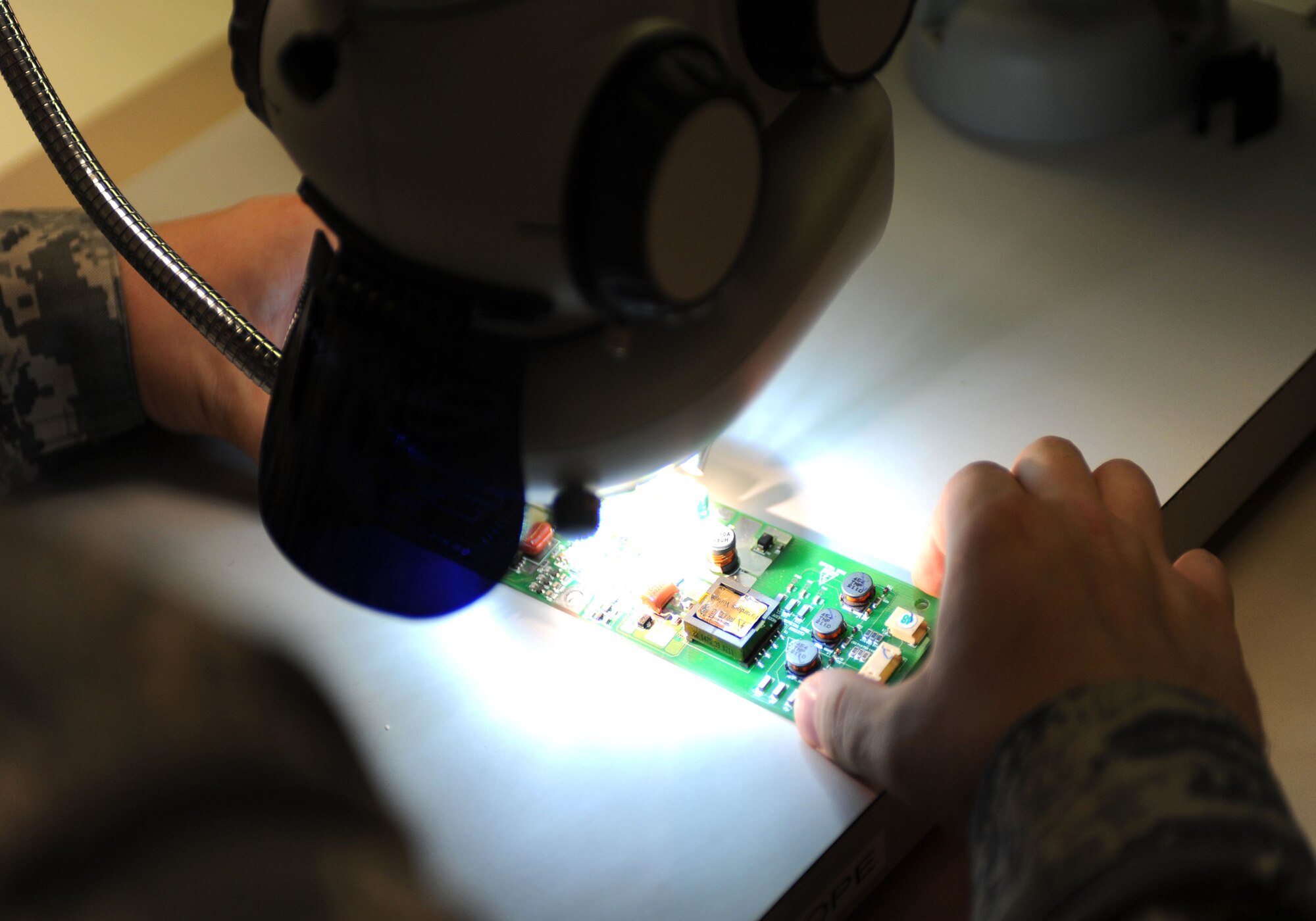CANNON AIR FORCE BASE, N.M. -- A circuit card for an LCD monitor is being inspected for damage at the Air Force Repair Enhancement Program building Nov. 5. At AFREP, Airmen work with advanced machinery to detect and repair malfunctioning circuits in equipment ranging from aircraft parts to office printers. The program saves the Air Force millions of dollars per year in equipment costs. (U.S. Air Force photo by Airman 1st Class Evelyn Chavez)