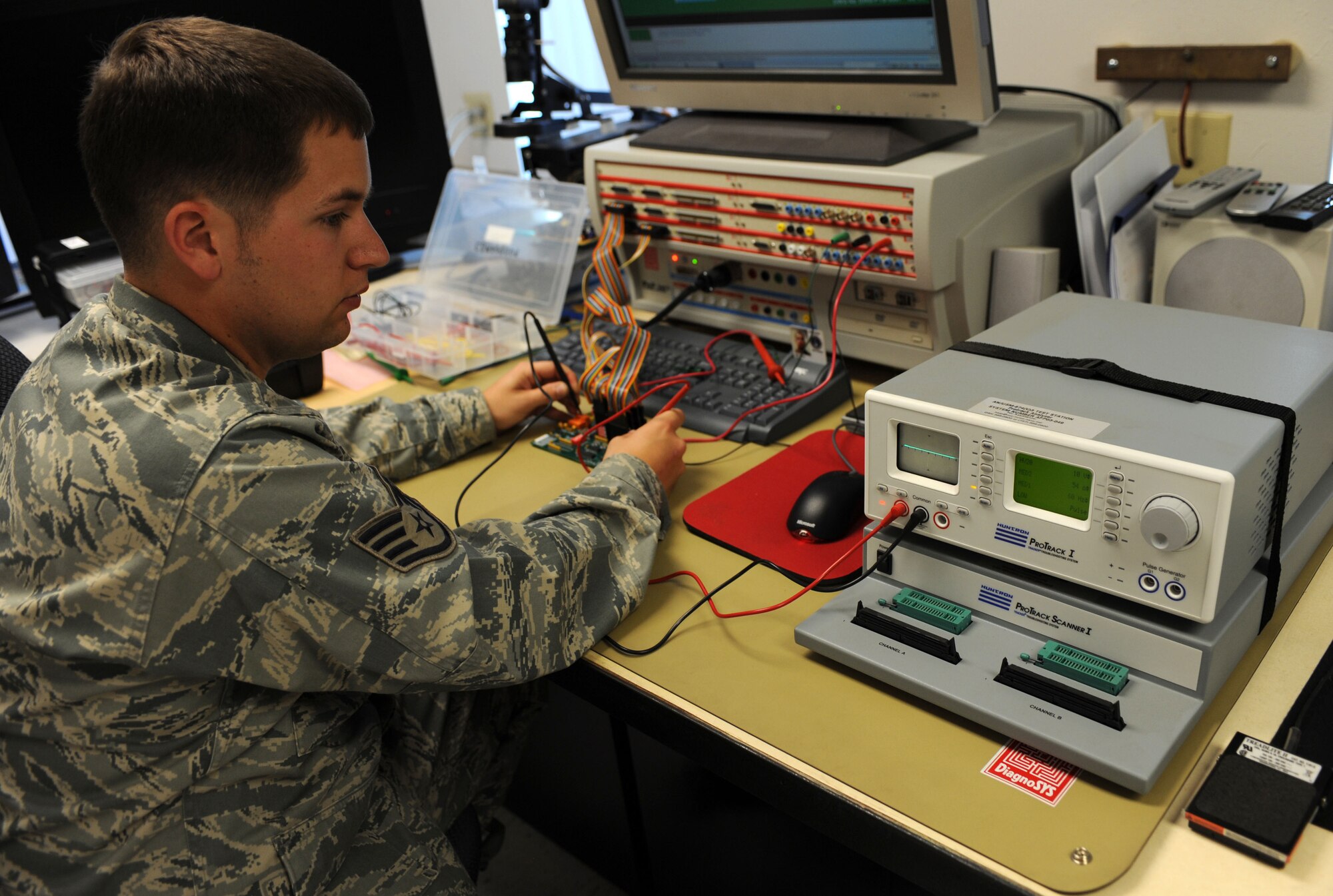 CANNON AIR FORCE BASE, N.M. -- Staff Sgt. Ryan Van Vels, 27th Special Operations Maintenance Group, inspects a circuit card using a system diagnostic machine. Through the Air Force Repair Enhancement Program, Airmen work with advanced machinery to detect and repair malfunctioning circuits in equipment ranging from aircraft parts to office printers. The program saves the Air Force millions of dollars per year in equipment costs. (U.S. Air Force photo by Airman 1st Class Evelyn Chavez)