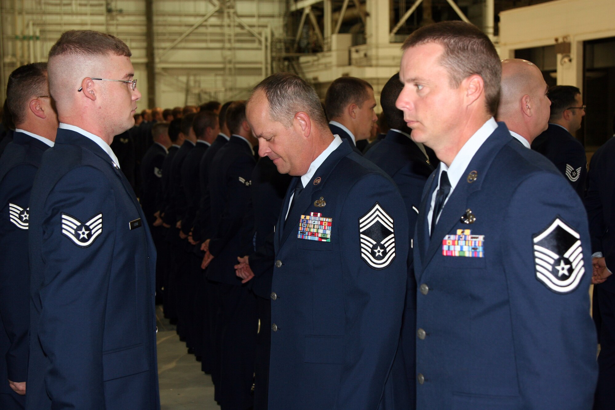 MCCONNELL AIR FORCE BASE, Kan. --  Chief Master Sgt. Bart Ellis and Master Sgt. Jeremy Polk scan over Staff Sgt. Brian Crews’s dress uniform during a 22nd Aircraft Maintenance Squadron open ranks inspection, on McConnell’s Wingman Day, Nov. 12. (Photo by Master Sergeant Brent Barr)