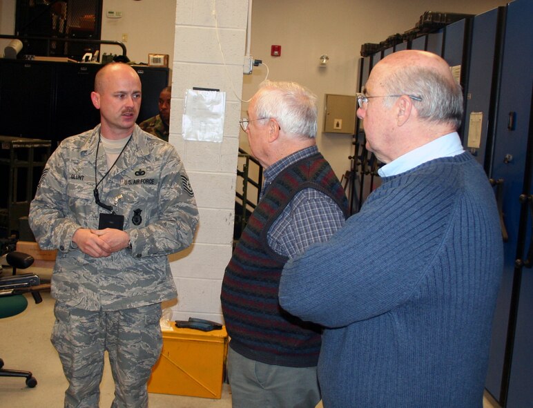Mr. Keith Ferris, an artist in the Air Force Art Program and honorary chairman of the New York Society of Illustrators, and Mr. John Witt, artist and current chairman of the NY Society, receive a tour of the U.S. Air Force Expeditionary Center armory from Tech. Sgt. Charles Glunt Nov. 18, 2008, on Fort Dix, N.J.  The two artists visited to learn about the EC mission and discuss future art projects covering EC training. (U.S. Air Force Photo/Tech. Sgt. Scott T. Sturkol)