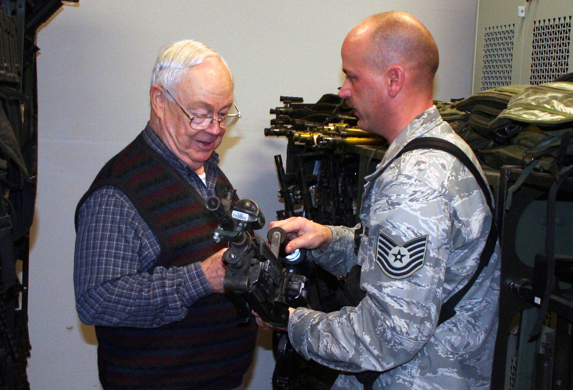 Mr. Keith Ferris, an artist in the Air Force Art Program and honorary chairman of the New York Society of Illustrators, talks with Tech. Sgt. Charles Glunt of the U.S. Air Force Expeditionary Center armory as he gets a tour of the armory Nov. 18, 2008, on Fort Dix, N.J..  Mr. Ferris and Mr. John Witt, also an artist and current chairman of the NY Society, visited the Expeditionary Center to learn about its mission and discuss future art projects covering EC training. (U.S. Air Force Photo/Tech. Sgt. Scott T. Sturkol)