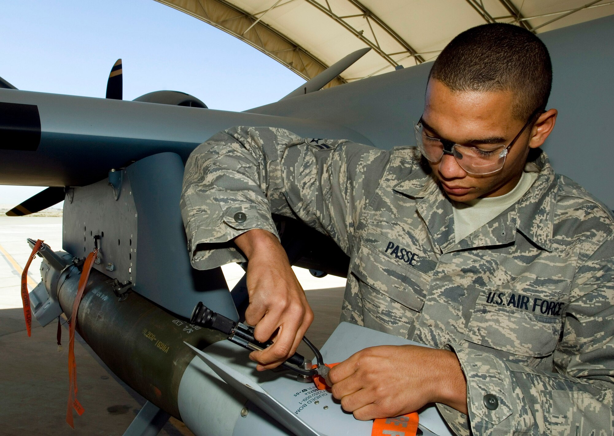 Airman 1st Class Gale Passe disarms a GBU-12 laser-guided munition attached to an MQ-9 Reaper unmanned aerial vehicle at Joint Base Balad, Iraq, Nov. 10. The Reaper can carry up to 3,750 pounds of ordnance, including GBU-12s and hellfire missiles. Airman Passe, an aircraft armament systems journeyman with the 332nd Expeditionary Aircraft Maintenance Squadron, is deployed from Creech Air Force Base, Nev. (U.S. Air Force photo/Tech. Sgt. Erik Gudmundson)