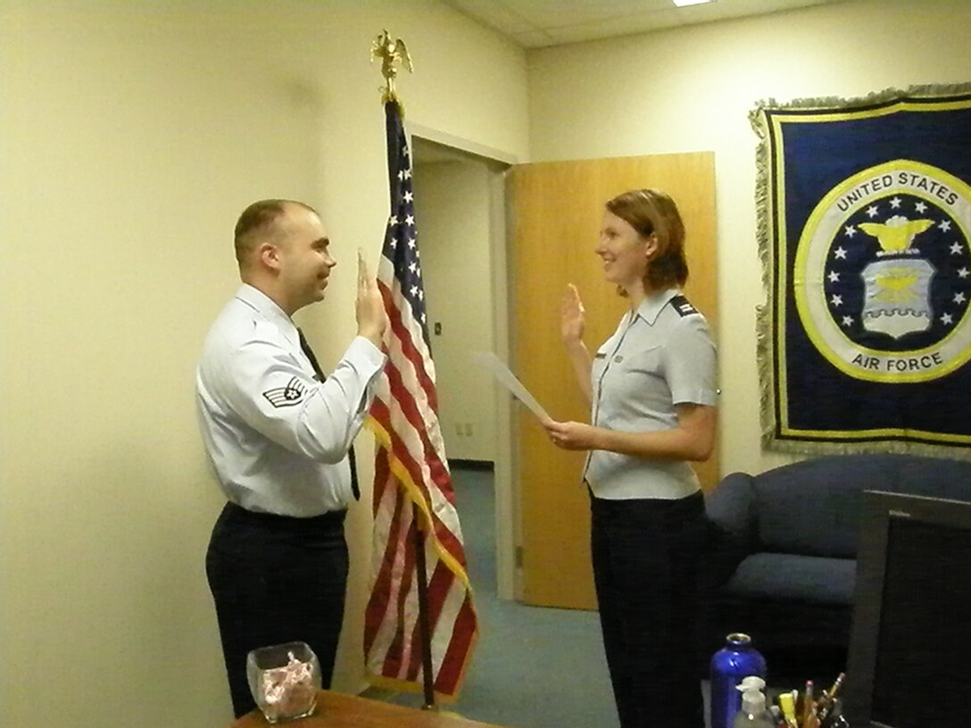 Staff Sgt. John Wade, 71st Flying Training Wing equal opportunity technician, resites the oath of enlistment with Capt. Jennifer Greig, 71st FTW EO chief, Nov. 17. Sergeant Wade has 11 years time in service and is technically re-enlisting for the first time (he had previously separated from the Air Force before enlisting a second time and going through the military entrance processing station procedures again). U.S. Air Force photo by Tech. Sgt. Debra Reddecliff.