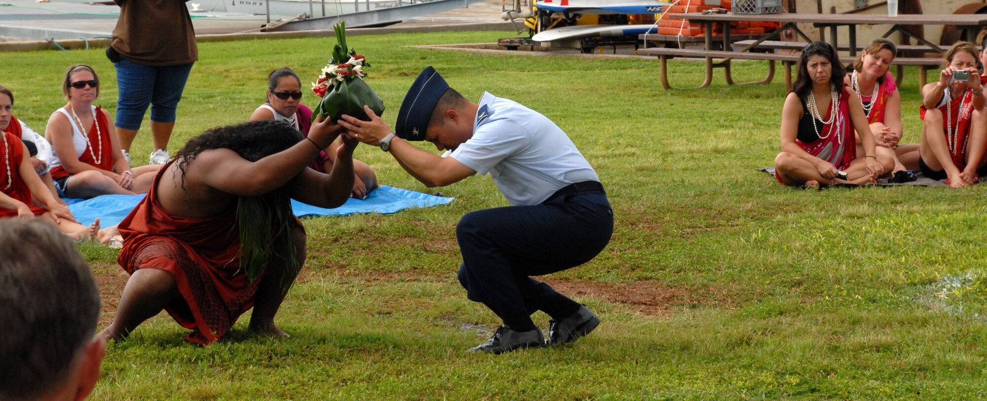 Col. Giovanni Tuck, 15th Airlift Wing commander, presents a gift to Lono, the defined guardian of agriculture, rain, health and peace during the annual Makahiki ceremony.  Makahiki participants presented flowers, leis, plants, fruits and agricultural gifts to Lono during the ceremony, similar to a Thanksgiving celebration. The ceremony was Saturday at Hickam Harbor. (U.S. Air Force Photo/Staff Sgt. Erin Smith)