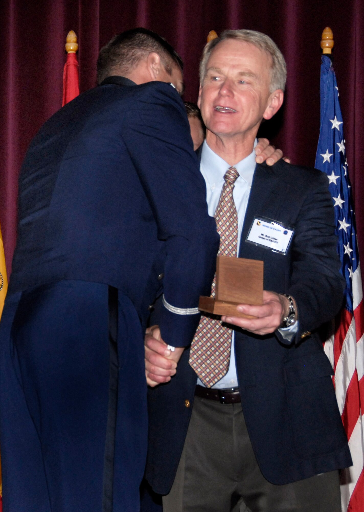 Second Lt. Ryan Bodenheimer shakes Bob Littler's hand and gives him a hug after presenting him with his son's, 2nd Lt. Alec Littler, wings posthumously during a ceremony at the Euro-NATO Joint Jet Pilot Training Program graduation Nov. 7 at Sheppard Air Force Base, Texas. Lieutenant Littler was killed May 1 during a T-38 Talon training mission when the aircraft crashed. He would have graduated with Class 08-08. (U.S. Air Force photo/Harry Tonemah) 
