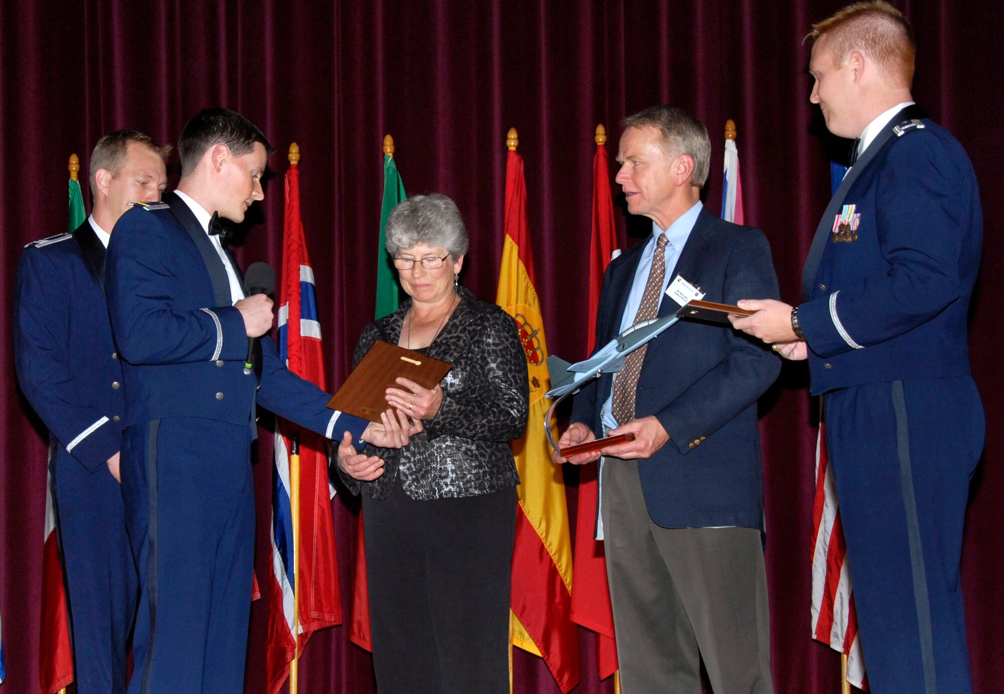Capt. Barak Amundson and 2nd Lt. Ryan Bodenheimer present Penny Farquhar with a plaque that memorializes her son, 2nd Lt. Alec Littler, while Bob Littler and Capt. Michael Hansen watch Nov. 7 at Sheppard Air Force Base, Texas. The 80th Flying Training Wing honored Lieutenant Littler during the Euro-NATO Joint Jet Pilot Training Program's graduation of Class 08-08. The lieutenant, who was killed during a May 1 training mission, was scheduled to graduate with Class 08-08. (U.S. Air Force photo/Harry Tonemah) 
