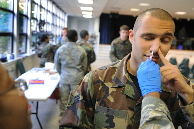 LANGLEY AIR FORCE BASE, Va -- Lt. Col. Dammen Vivene, 1st Medical Group maternal child flight commander, administers flu vaccine to Airman 1st Class Jade Pina, 1st Comptroller Squadron finance technician, Oct. 29. Flu vaccines will be available for all Department of Defense identification cardholders at the Bateman Library Nov. 24 from 8 a.m. to 4 p.m. and Nov. 26 from 8 a.m. to noon.   (U.S. Air Force photo/Senior Airman Vernon Young)