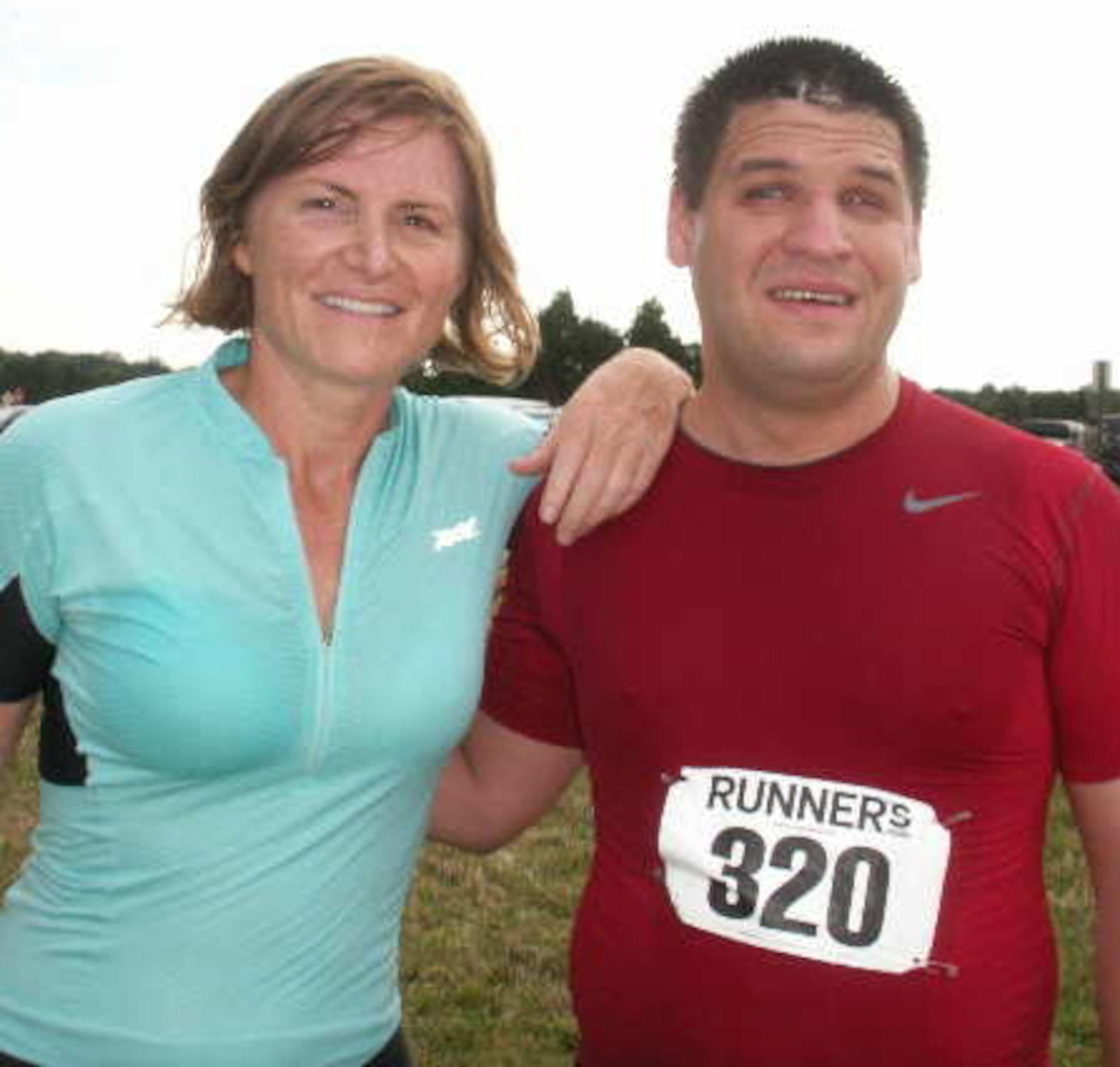 Maj. Kelli Molter, aide-de-camp to the commander of Air Force Reserve Command in the Pentagon, poses with Chad Fenton after a triathlon. Mr. Fenton, who is blind, is personally trained and coached by Major Molter, who uses her Ironman experiences to assist physically disabled individuals compete in sporting events. (Courtesy photo)