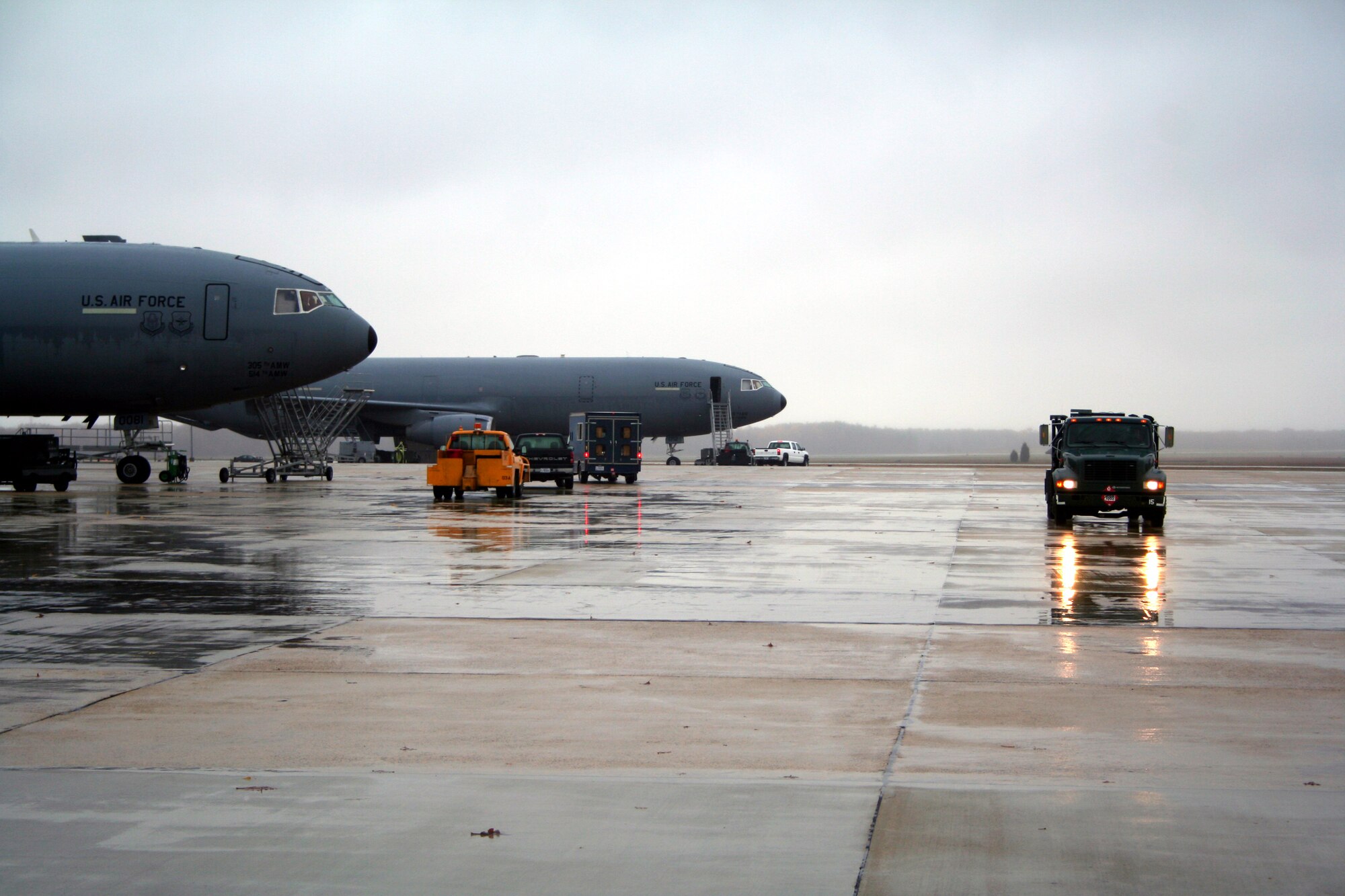 A refueling truck makes its way down the ramp while other activity takes place on the McGuire Air Force Base, N.J., flightline Nov. 6, 2008.  McGuire is one of the bases supporting Air Mobility Command and the Air Force in its mission to "fly, fight and win ... in air, space and cyberspace."  (U.S. Air Force Photo/Tech. Sgt. Scott T. Sturkol)