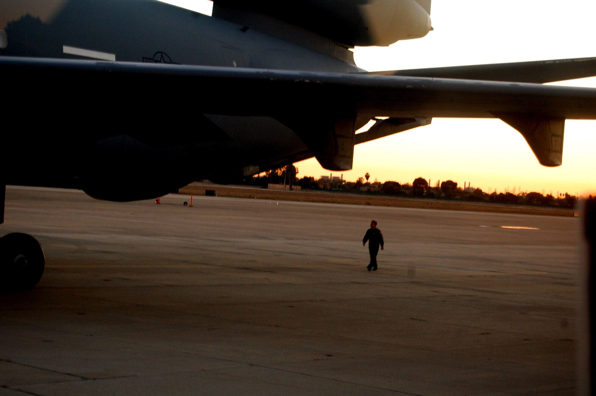 A KC-10 Extender aircrew member from McGuire Air Force Base, N.J., inspects the back of a KC-10 at Joint Forces Training Base, Los Alamitos, Calif., Nov. 6, 2008. The inspection was part of post-flight checklist.  The KC-10 is one of the aircraft stationed at McGuire that helps Air Mobility Command and the Air Force "fly, fight and win ... in air, space and cyberspace."  (U.S. Air Force Photo/Tech. Sgt. Scott T. Sturkol)