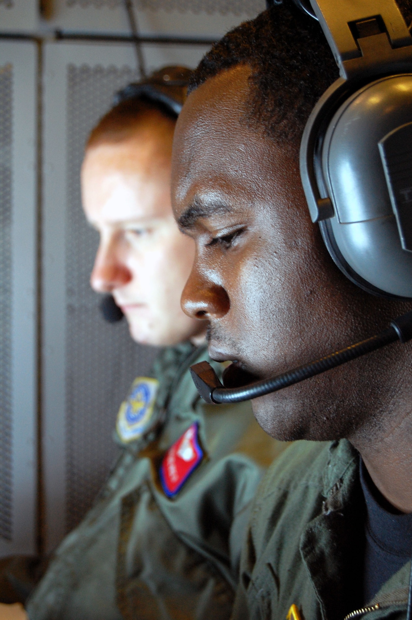 Airman Christopher Nixon, 2nd Air Refueling Squadron, receives instruction from Staff Sgt. Carl Wise II, 305th Operations Support Squadron KC-10 Formal Training Unit, during an air refueling in a KC-10 Extender from McGuire Air Force Base, N.J., Nov. 6, 2008, over the central United States.  Both Sergeant Wise and Airman Nixon are boom operators.  (U.S. Air Force Photo/Tech. Sgt. Scott T. Sturkol)