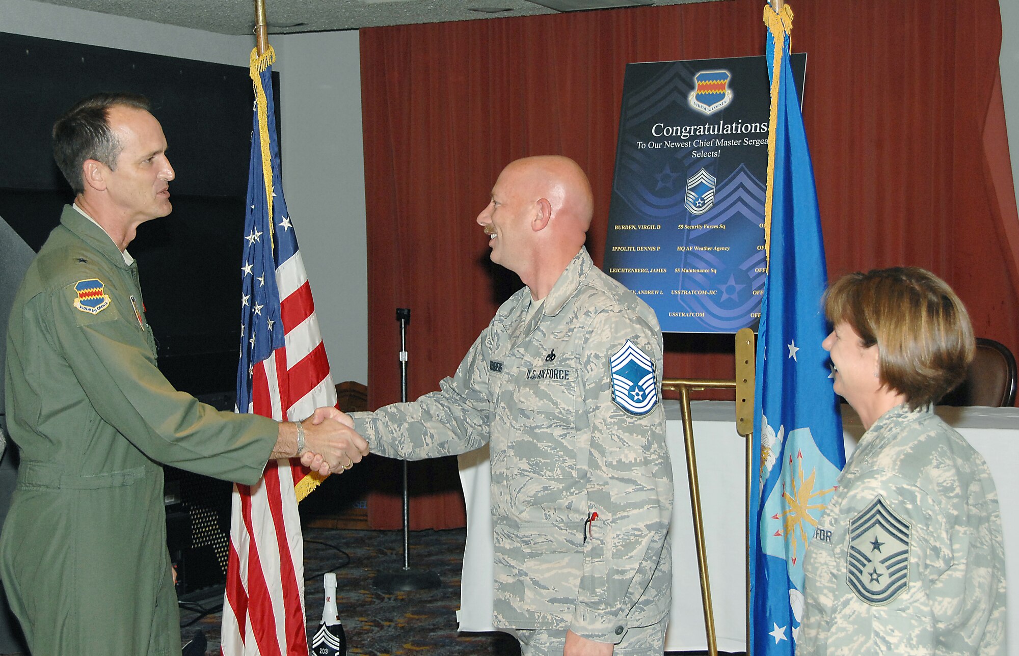 OFFUTT AIR FORCE BASE, Neb. -- Senior Master Sgt. James Leichtenberg, 55 Maintenance Group, recieves a congratulatory hand shake from Brig. Gen. James Jones, 55 Wing commander, as Command Chief Master Sgt. Lisa Sirois, 55 Wing command chief master sgt., looks on during the chief's promotion at the Patriot Club, Nov. 14. The rank of chief master sgt. is only attained by the top one percent of the U.S. Air Force's enlisted corps.  ( U.S. Air Force Photo By Dana Heard )