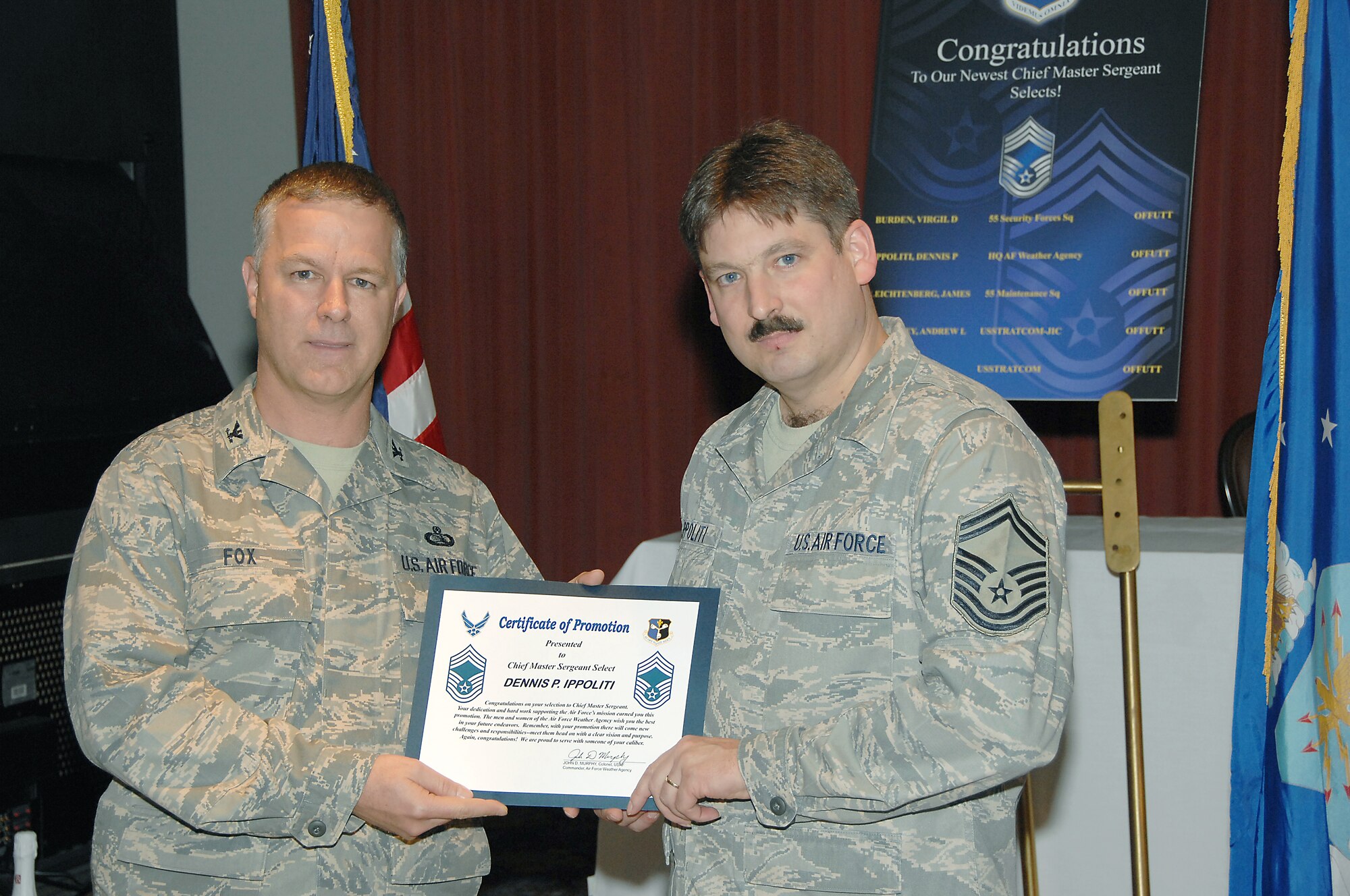 OFFUTT AIR FORCE BASE, Neb. -- Senior Master Sgt. Dennis Ippoliti, Air Force Weather Agency, receives his Certificate of Promotion from Col. Kurt Fox, Air Force Weather Agency, during the chief's promption at the Patriot Club, Nov. 14. The rank of chief master sgt. is only attained by the top one percent of the Air Force's enlisted corps.  (U.S. Air Force Photo By Dana Heard)