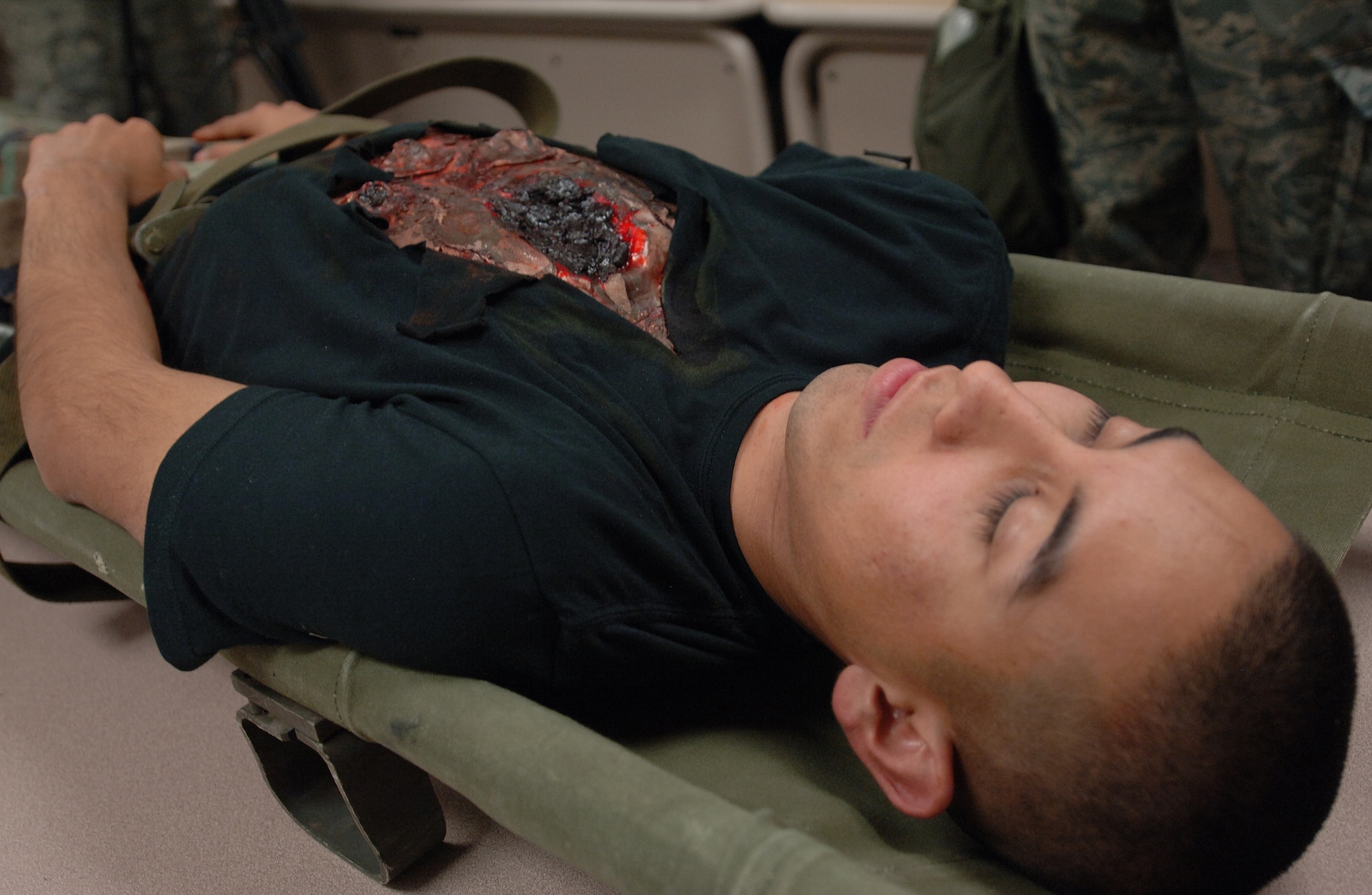 Airman 1st Class Gabriel Castillo, 49th Force Support Squadron, plays a casualty that was brought to the mortuary at Holloman Air Force Base, N.M., Nov.18, for the phase II exercise, Cornet Gold Rush 08-08. (U.S. Air Force photo/Airman 1st Class Michael Means)