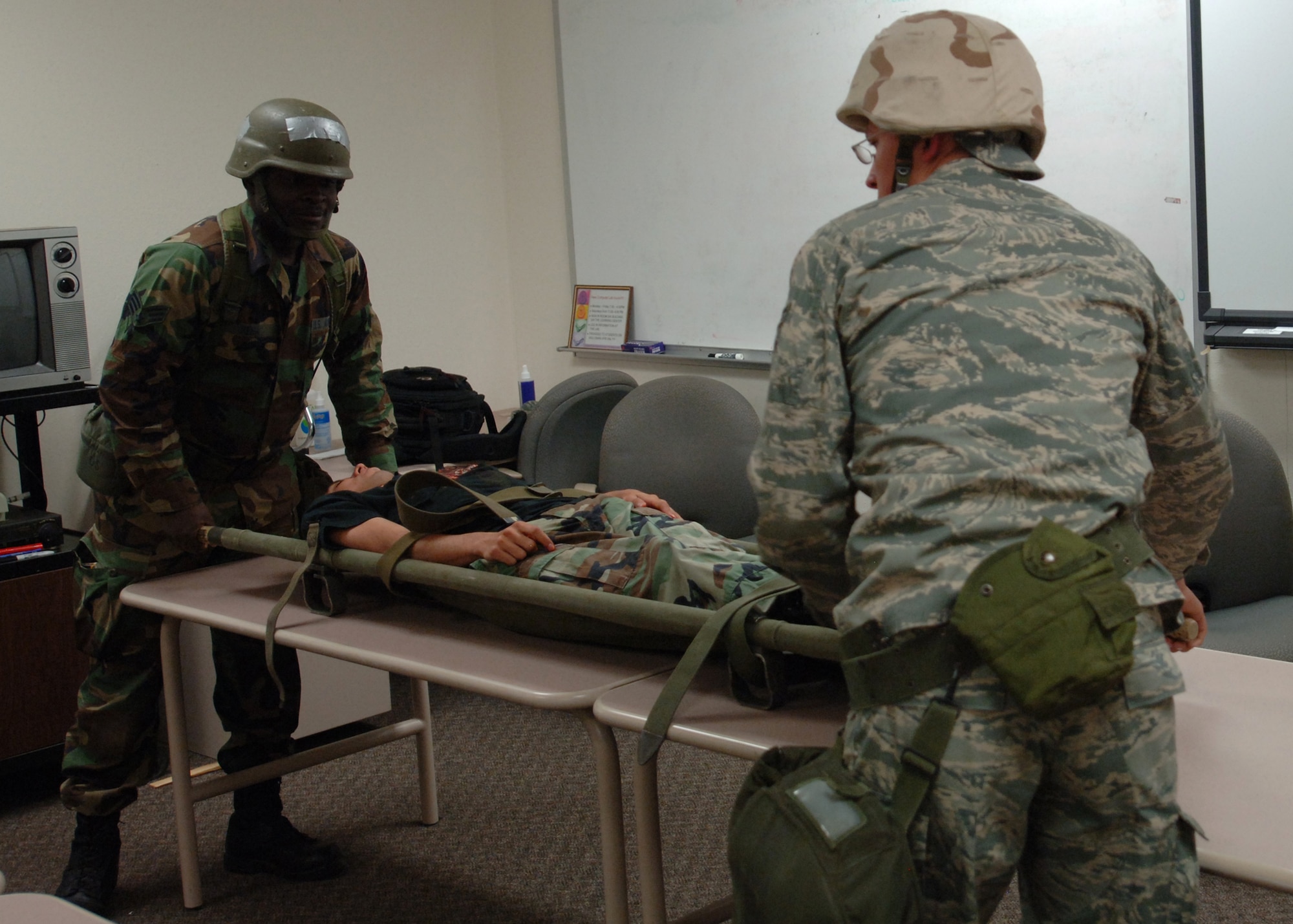 Airmen from the 49th Force Support Squadron bring a casualty, played by Airman 1st Class Gabriel Castillo, to the mortuary at Holloman Air Force Base, N.M., Nov.18.  Casualties were brought to the mortuary for processing for the Phase II exercise, Cornet Gold Rush 08-08. (U.S. Air Force photo/Airman 1st Class Michael Means)