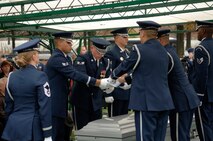Members of US Air Force Honor Guard fold the American flag at a group burial service for six crewmembers of a B-52 that crashed 21 July 2008 off Guam’s Northwest coast.  Five of the crew members were stationed at Barksdale AFB, LA  deployed to Guam with the 20th Expeditionary Bomb Squadron as part of DOD's continuous bomber presence mission in the Pacific.  The sixth crewmember was the deputy commander of 36th Medical Group at Andersen Air Force Base, Guam. (Air Force photo by Thomas Dennis) 
