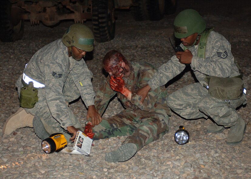 Senior Airman Joseph Petty and Staff Sgt Charles Jenkins, 49th Logistics Readiness Squadron, administers self-aid and buddy care to a victim played by Senior Airman Jacob Johnson, 49th Aircraft Maintenance Squadron, at Holloman Air Force Base, N.M., Nov.17. Airman Petty and Sgt. Jenkins were doing post-attack reconnaissance for the phase II exercise, Cornet Gold Rush 08-08. (U.S. Air Force photo/Airman 1st Class Michael Means)