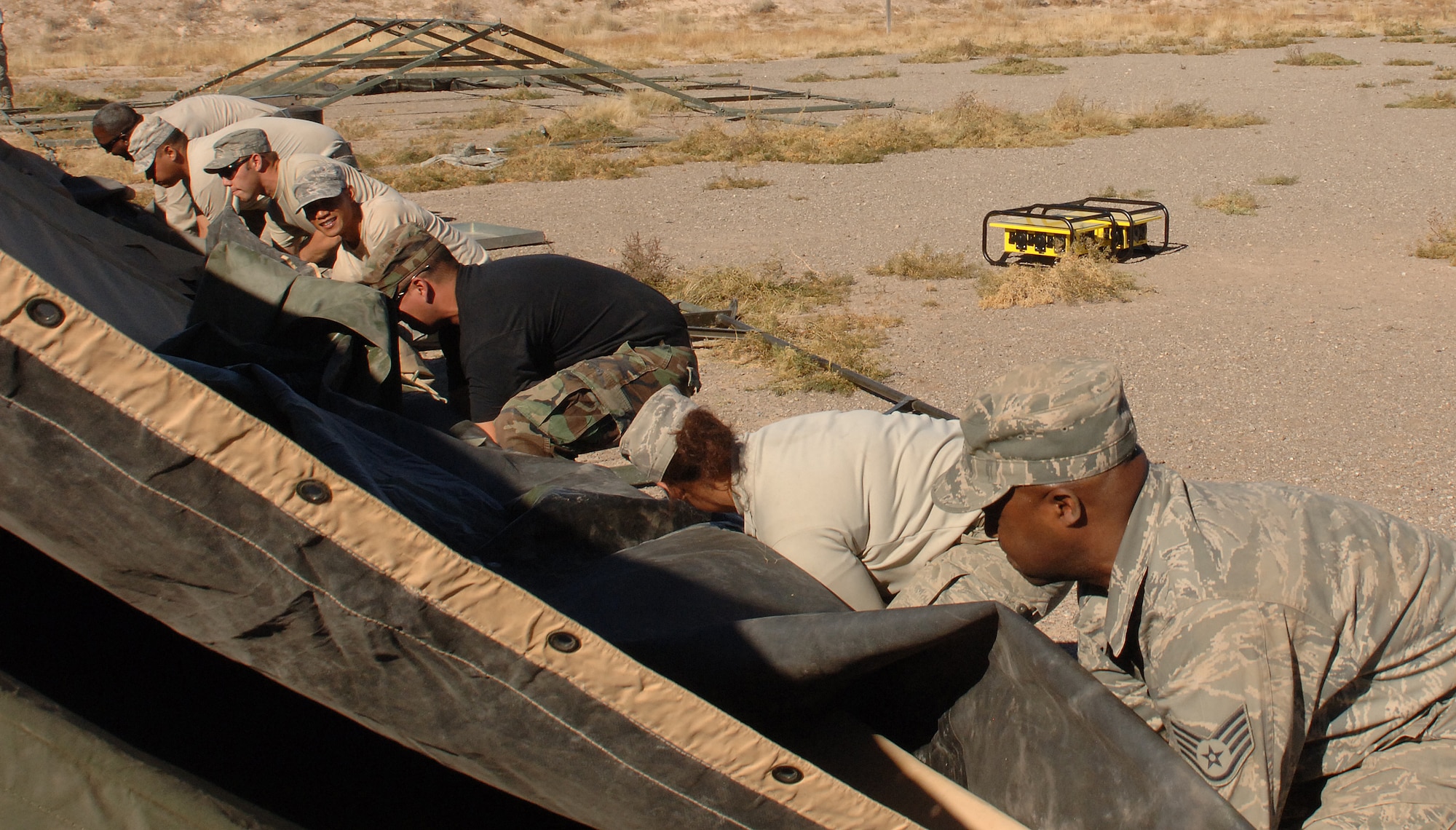 Airmen from the 49th Civil Engineer Squadron help set up tents at the CE pit, a simulated deployed environemnt, for the phase II exercise, Cornet Gold Rush 08-08 at Holloman Air Force Base, N.M., Nov. 17. (U.S. Air Force photo/Airman 1st Class Michael Means)
