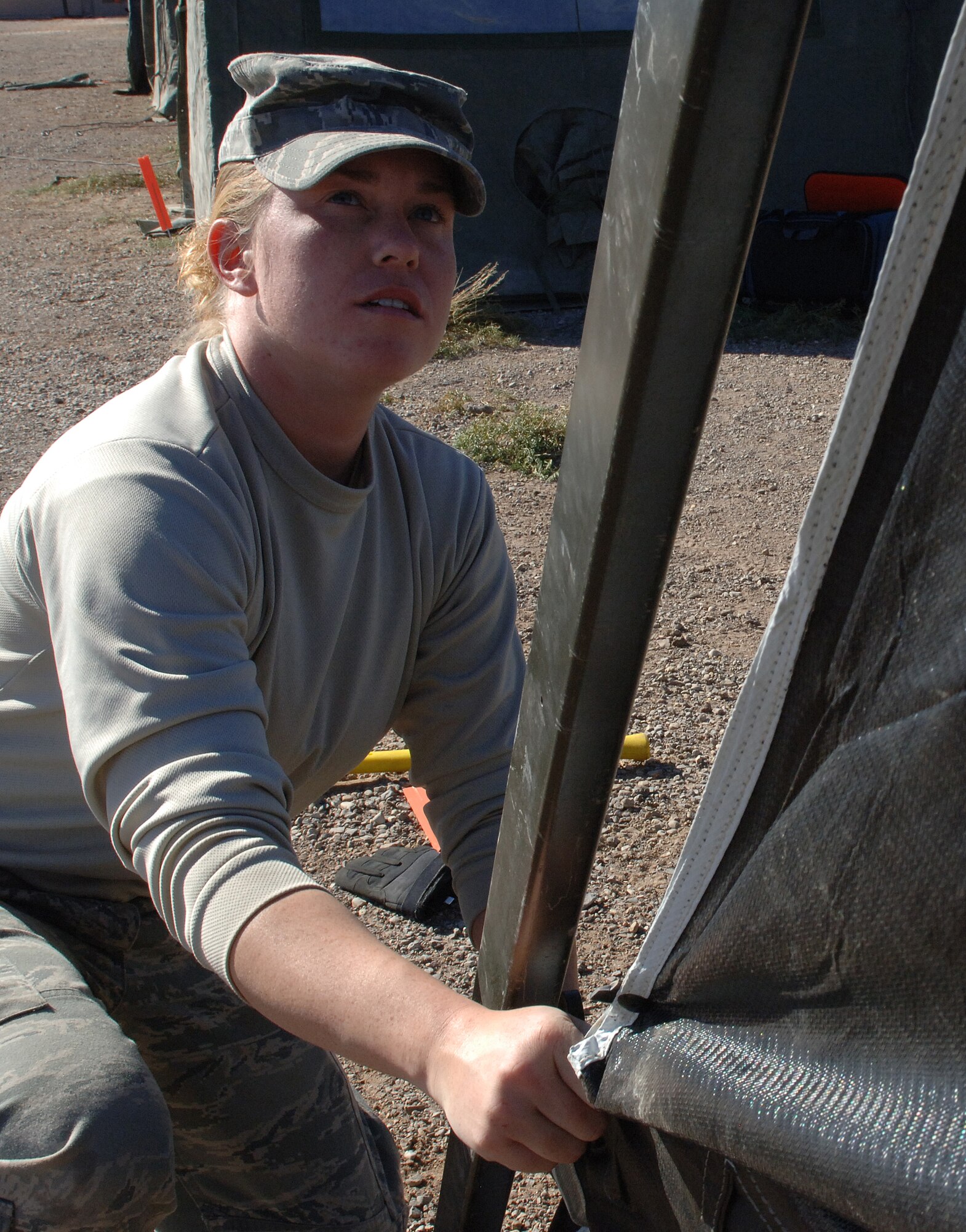 Airman 1st Class Krista Lawrence, 49th Civil Engineer Squadron, helps set up tents at the CE pit, a simulated deployed environment, for the phase II exercise, Cornet Gold Rush 08-08 at Holloman Air Force Base, N.M., Nov. 17. (U.S. Air Force photo/Airman 1st Class Michael Means)