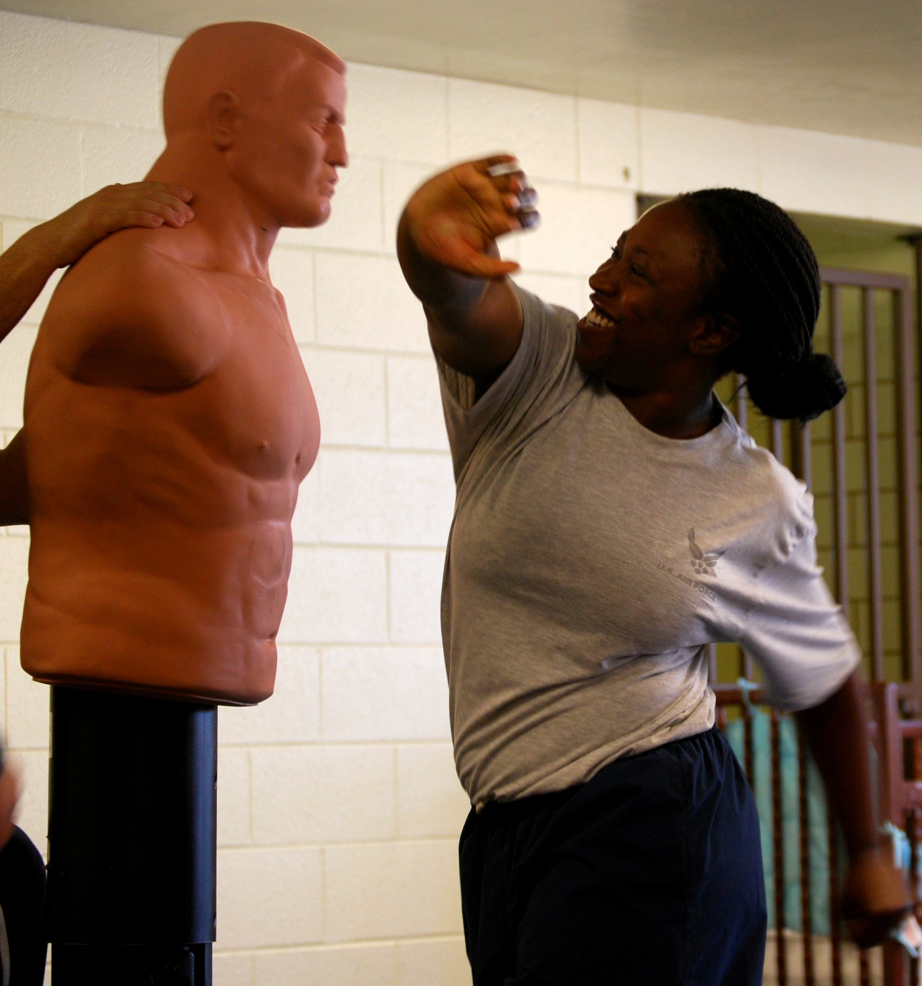 Airman 1st Class Markeya Lucas-Drisdom practices an offensive move on an "attacker" Nov. 15 during a Target hardening class. Airman Lucas-Drisdom and other females attending the course learn how to become a hard target. (U.S. Air Force photo/Staff Sgt. Cunningham)