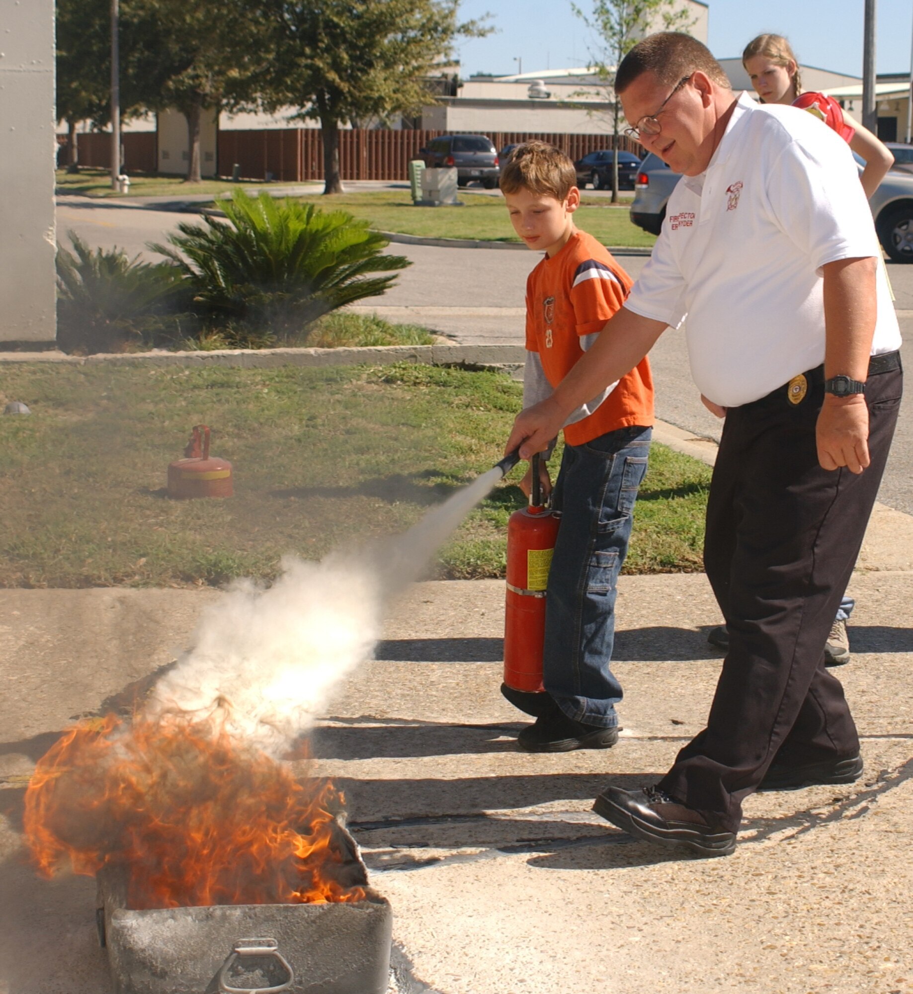Mr. Snyder demonstrates the use of a fire extinguisher at last year’s Fire Prevention Week open house.  (U.S. Air Force photo by Kemberly Groue)