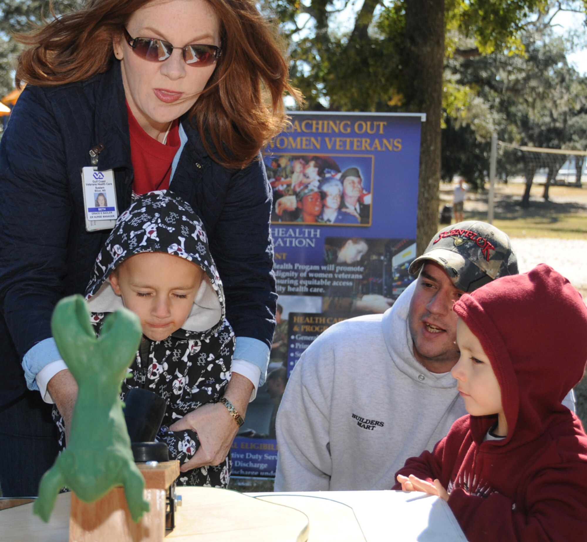 From left, Beth Sadler from the Biloxi Veterans Affairs Medical Center plays “frog hop” with Cody Hunter, 5, as his dad, Staff Sgt. Cory Hunter, and brother Ryan, 3, watch.  Keesler and the VA co-sponsored the picnic and information expo for veterans of Operations Iraqi Freedom and Enduring Freedom at marina park Saturday.  Sergeant Hunter is from the 81st Security Forces Squadron.  (U.S. Air Force photo by Kemberly Groue)