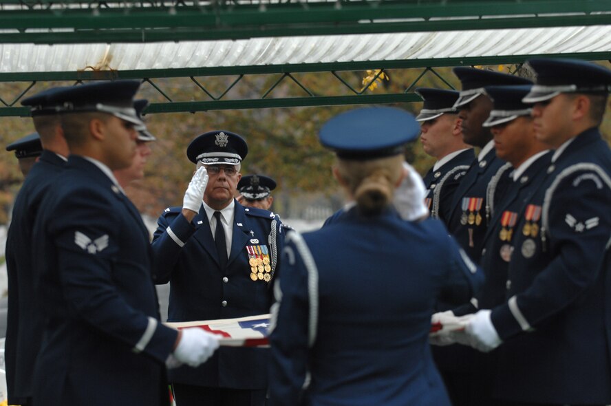 Chaplain (Col.) Charlie Stutts renders a salute prior to the flag folding at a group burial ceremony Nov. 14 at Arlington National Cemetery in Virginia. The group burial ceremony was held for six crewmembers that perished in a July 21 B-52 Stratofortress crash off Guam's Northwest coast. (U.S. Air Force photo/Staff Sgt. Catherine Thompson) 