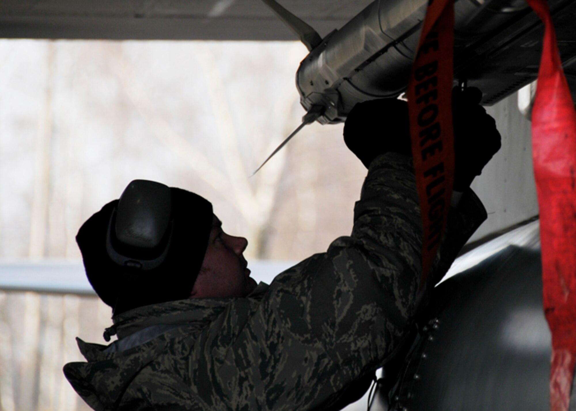 Staff Sgt. Kristopher Glenn, 493rd Expeditionary Fighter Squadron weapons loader, inspects the missiles on an F-15 Eagle after landing in Siauliai, Lithuania, Nov. 11. Sergeant Glenn ensures the weapons are secured to the aircraft and makes any necessary adjustments due to movement in flight.