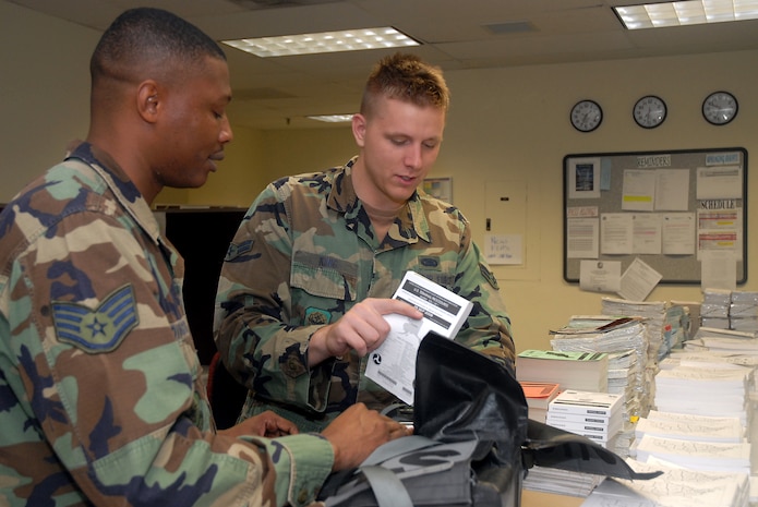 Staff Sgt. Michael Covington and Airman 1st Class Eric King inspect flight information publication kits on base Nov. 17. The 437th Operations Support Squadron Combat Crew Communications Flight stocks, builds and maintains approximately 100 FLIPs a week based on the route of flight for C-17 missions. Sergeant Covington and Airman King are with the 437 OSS. (U.S. Air Force photo/Airman 1st Class Melissa White)