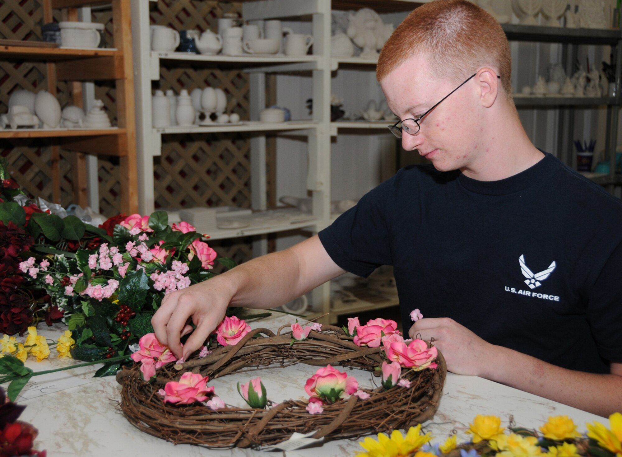 Airman Basic Kyle Baranyk, 336th Training Squadron, makes and sells wreaths at the craft fair.  (U.S. Air Force photo by Kemberly Groue)