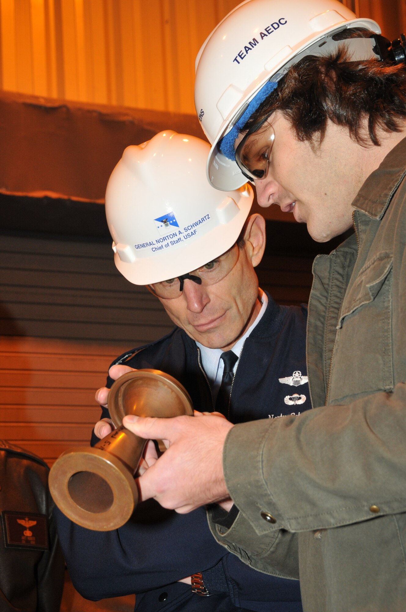 Gary Hammock, an arcs and ranges analysis engineer, explains how the H3 Arc Heater Facility works to the Chief of Staff of the Air Force Gen. Norton Schwartz. (Photo by David Housch)