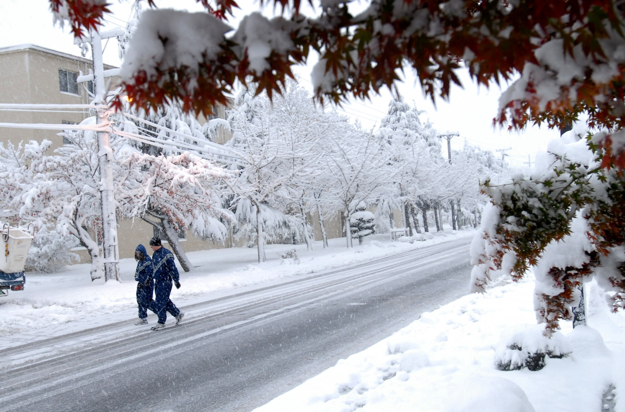 8th Fighter Wing Airmen head home through the snow after morning PT at Kunsan Air Base, Republic of Korea, Nov. 19, 2008. Kunsan received more eight inches of snow during the first winter storm of 2008. (U.S. Air Force Photo by Master Sgt John M. Foster)