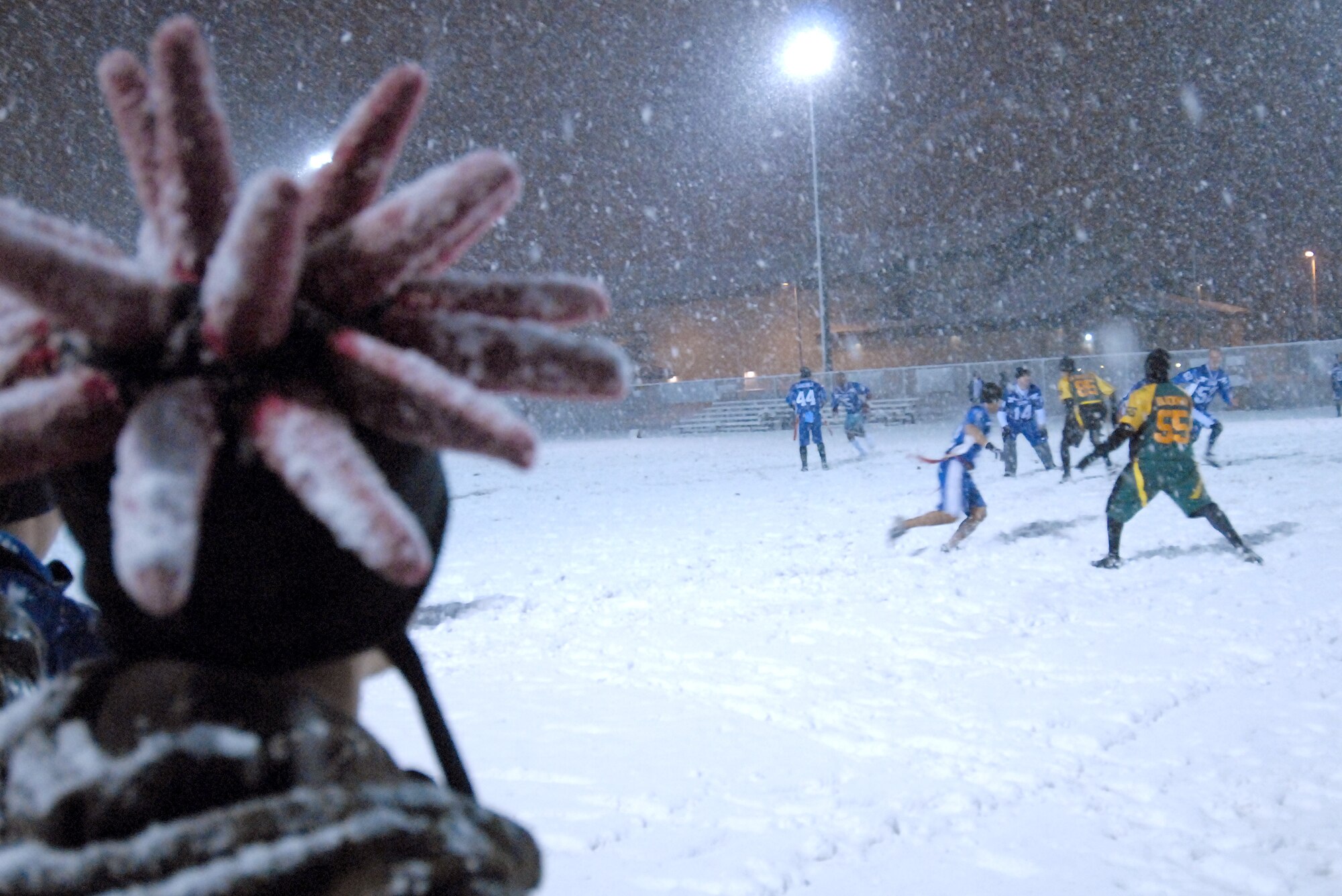 A Wolf Pack football fan watches the 8th Communications Squadron takes on the 8th Maintenance Squadron at Kunsan Air Base, Republic of Korea Nov. 18, 2008. The more than 8 inches of snow that fell overnight during Kunsan's first winter snowfall, did little to dampen the teams' and the supporters' spirits.  (U.S. Air Force Photo By: Master Sgt. John M. Foster)