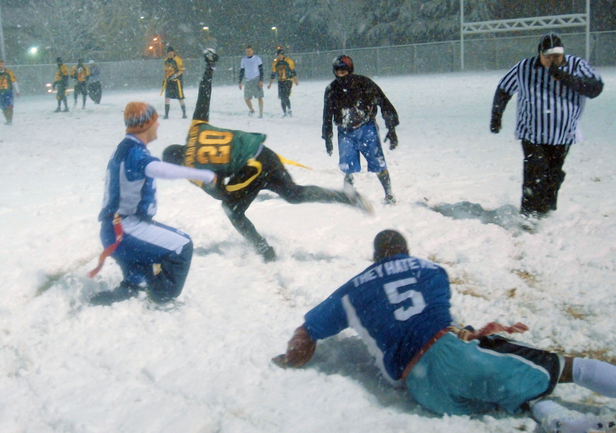 Wolf Pack flag-football continues in the snow as the 8th Communications Squadron takes on the 8th Maintenance Squadron at Kunsan Air Base, Republic of Korea Nov. 18, 2008. The more than 8 inches of snow that fell overnight during Kunsan's first winter snowfall, did little to dampen the teams' and the supporters' spirits.  (U.S. Air Force Photo By: MSgt John M. Foster)