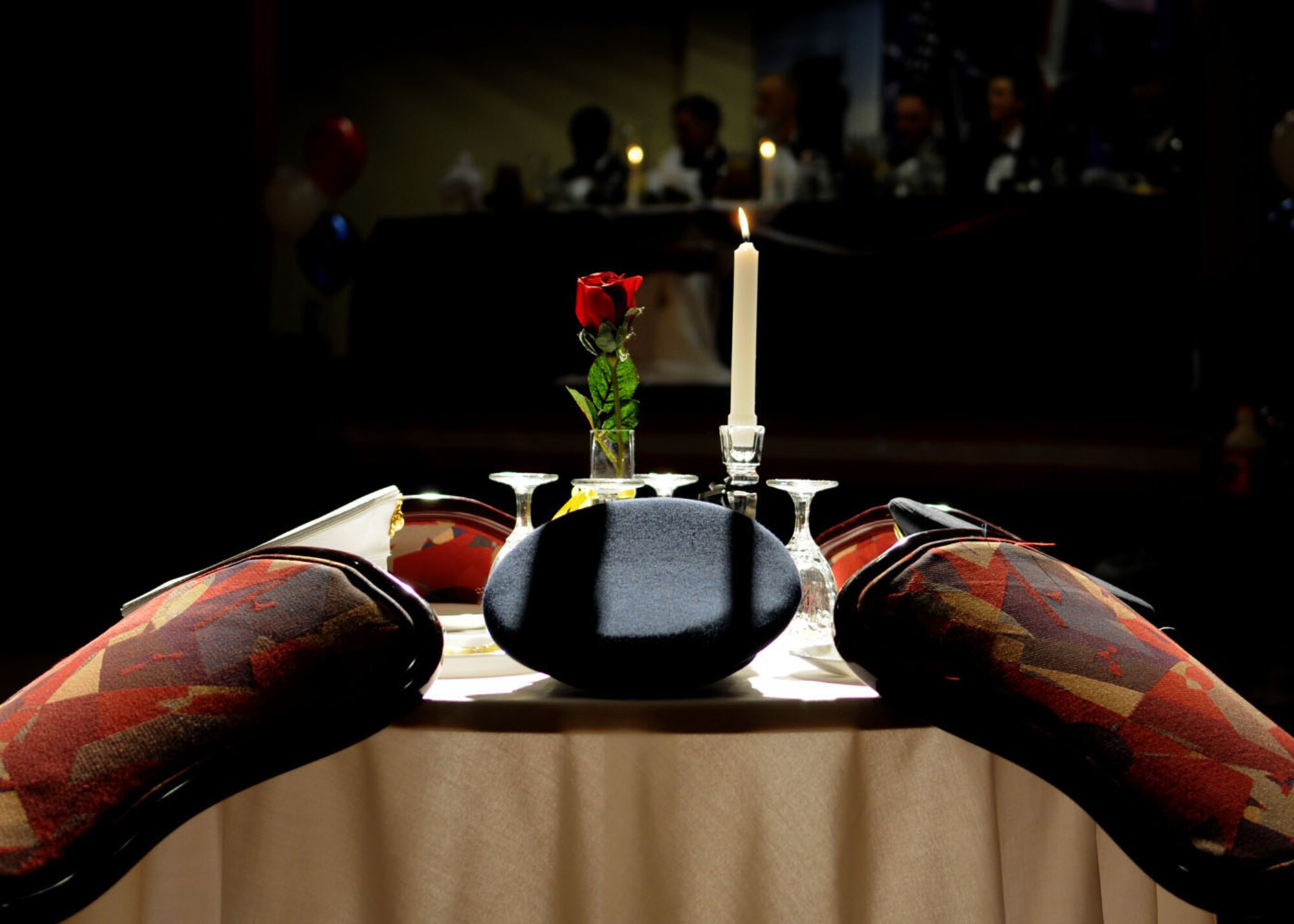 The POW/MIA table honors missing servicemembers from all branches of service who could not join be present during the Team Mildenhall Dining In at the Galaxy club Nov. 14, 2008, at RAF Mildenhall, England. Even though not present, the table and each item represented symbolize the love and sacrifice given by missing servicemembers and that they join the celebration in spirit. (U.S. Air Force photo by Staff Sgt. Jerry Fleshman)