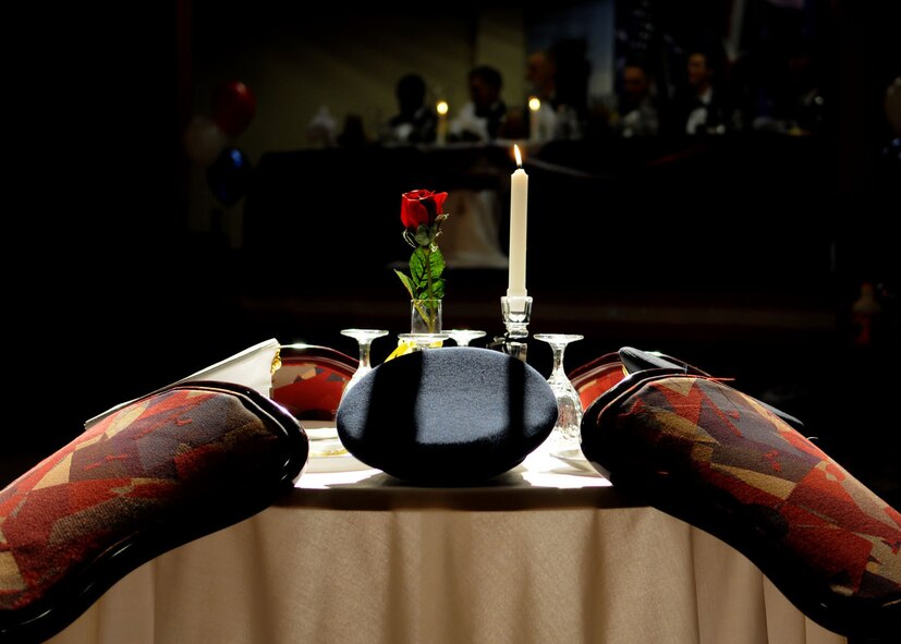 The POW/MIA table honors missing servicemembers from all branches of service who could not join be present during the Team Mildenhall Dining In at the Galaxy club Nov. 14, 2008, at RAF Mildenhall, England. Even though not present, the table and each item represented symbolize the love and sacrifice given by missing servicemembers and that they join the celebration in spirit. (U.S. Air Force photo by Staff Sgt. Jerry Fleshman)