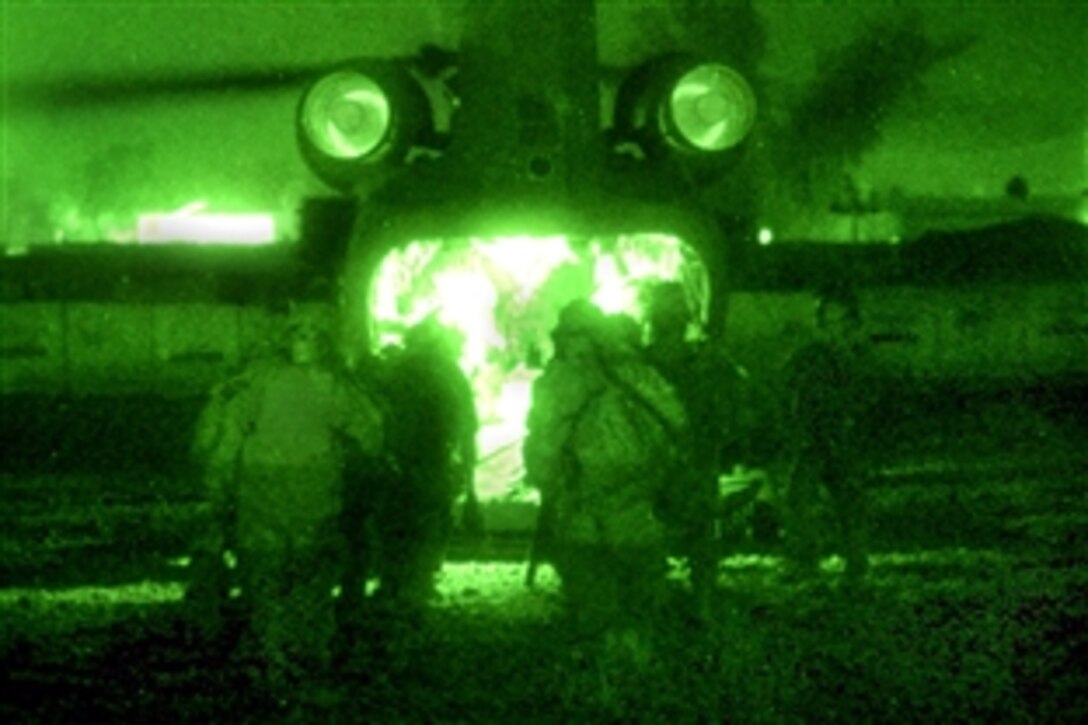 As seen through a night-viewing device, U.S. Army soldiers board a CH-47 Chinook helicopter on Forward Operating Base War Eagle in northern Adhamiyah, Iraq, Nov, 17, 2008. The soldiers are assigned to the 4th Infantry Division's Company B, 1st Combined Arms Battalion, 68th Armor Regiment. The soldiers were preparing for a mission in the Istaqlal District to disrupt the car bombing threat in northern Baghdad.