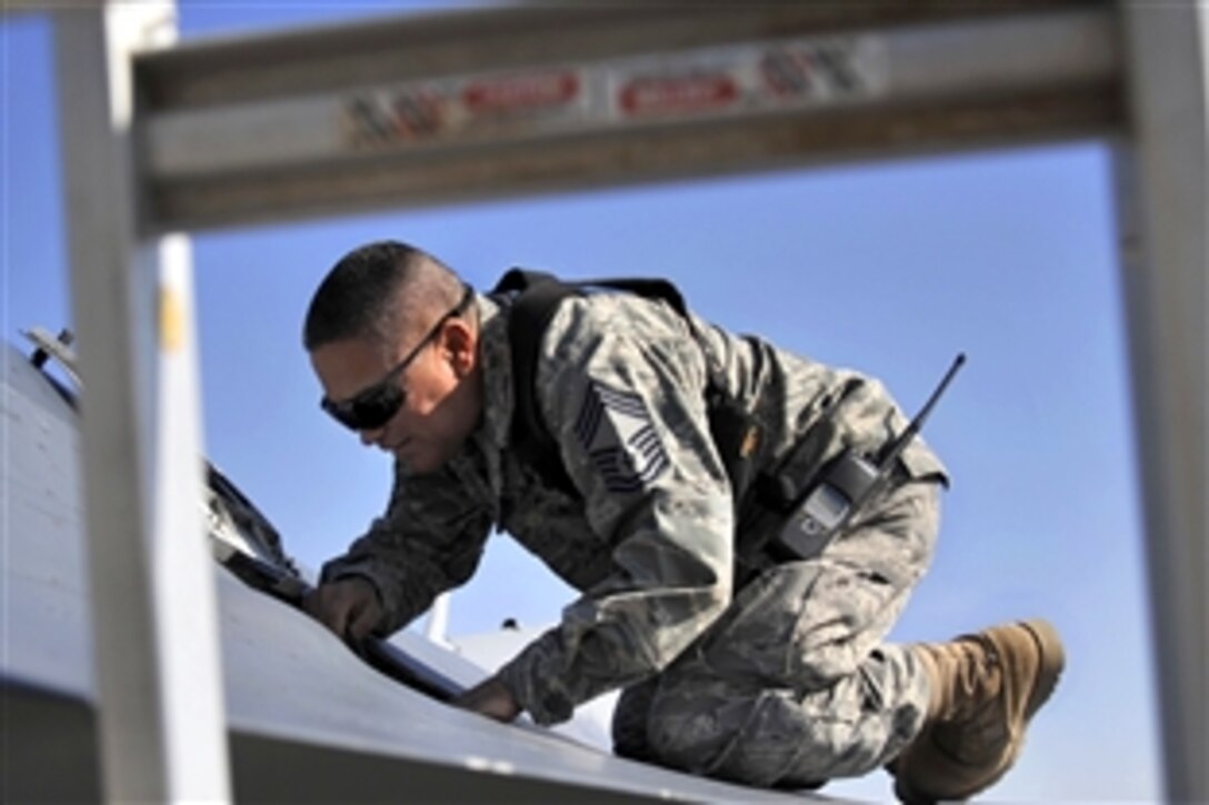 U.S. Air Force Chief Master Sgt. Pablo Valverde ensures the 20mm M61-A1 Gatling gun is  functioning properly on an F-16 Fighting Falcon after the pilot of the aircraft made an emergency landing at Baghdad International Airport, Iraq, Nov. 12, 2008. Valverde is assigned to the 447th Air Expeditionary Group.
