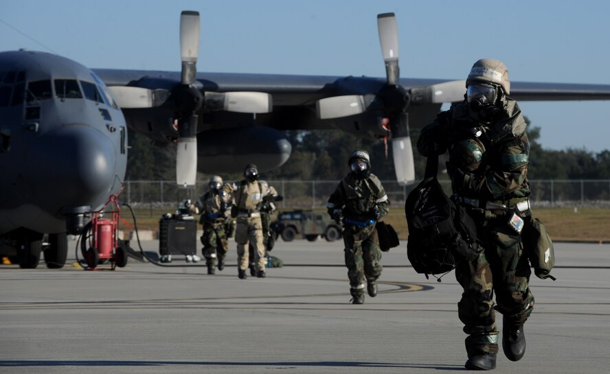 MOODY AIR FORCE BASE, Ga. -- Airmen from the 723rd Aircraft Maintenance Squadron run toward a simulated bunker in mission oriented protective posture level four ensemble during an operational readiness exercise here Nov. 20. Moody personnel participated in various wartime scenarios during the exercise. (U.S. Air Force photo by Senior Airman Gina Chiaverotti)