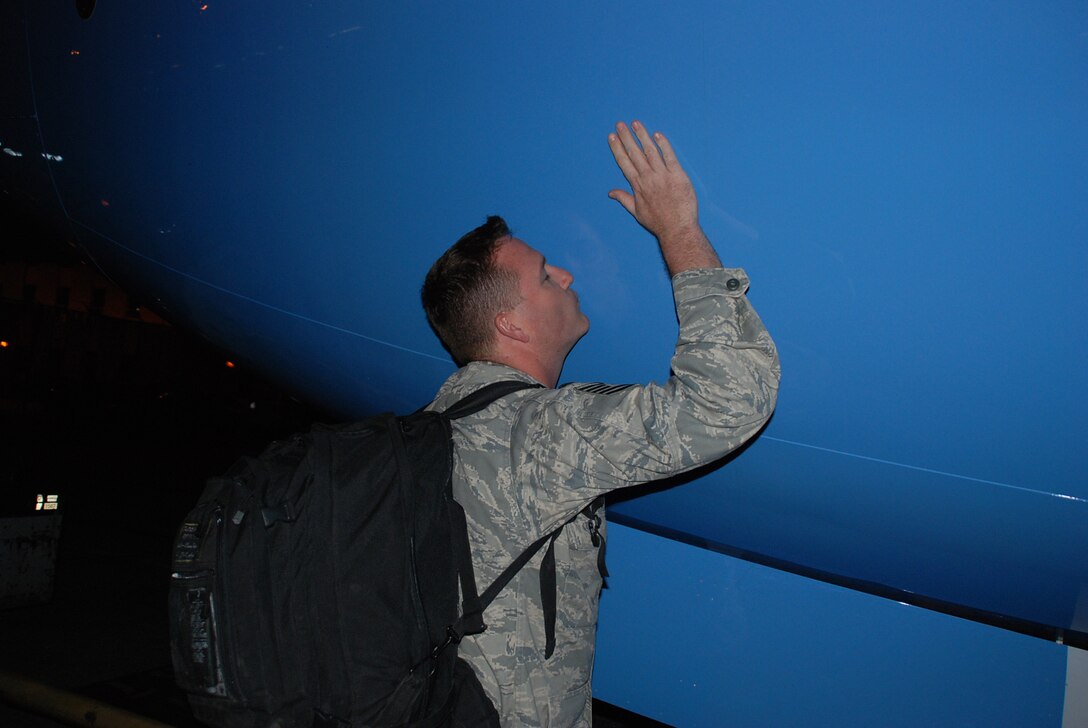 A 932nd Airlift Wing member kisses the nose of the unit's C-40C plane after he returned from an overseas deployment recently and landed at Scott Air Force Base, Ill.  (U.S. Air Force photo/Tech. Sgt. Dan Oliver)