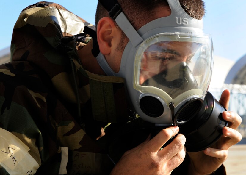 MOODY AIR FORCE BASE, Ga. -- Senior Airman Joshua Winchell, 23rd Aircraft Maintenance Squadron, A-10C Thunderbolt II crew chief, dons a gas mask while working on the aircraft here Nov. 20. Airman Winchell participated in a base wide exercise that required players to dress in mission-oriented protective postures. (U.S. Air Force photo by Senior Airman Brittany Barker)

