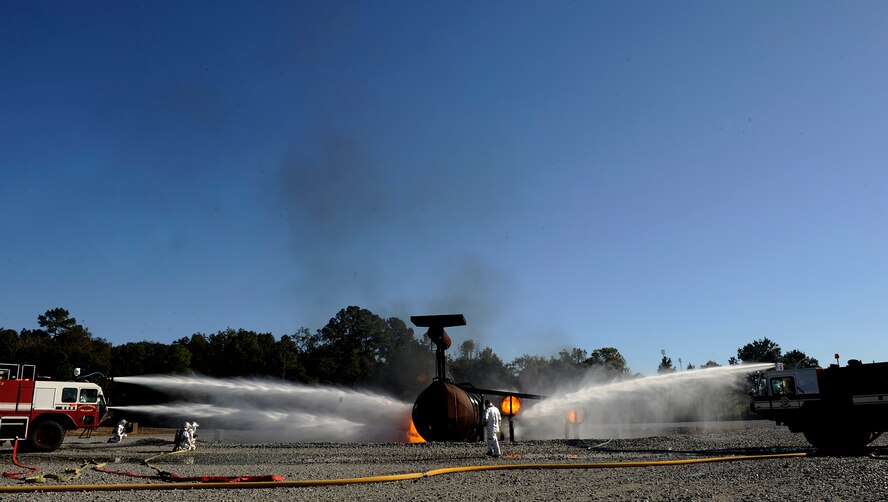 MOODY AIR FORCE BASE, Ga. -- 23rd Civil Engineer Squadron fire fighters extinguish the flames from a simulated HC-130P Hercules crash while participating in an exercise here Nov. 17. (U.S. Air Force photo by Senior Airman Brittany Barker) 