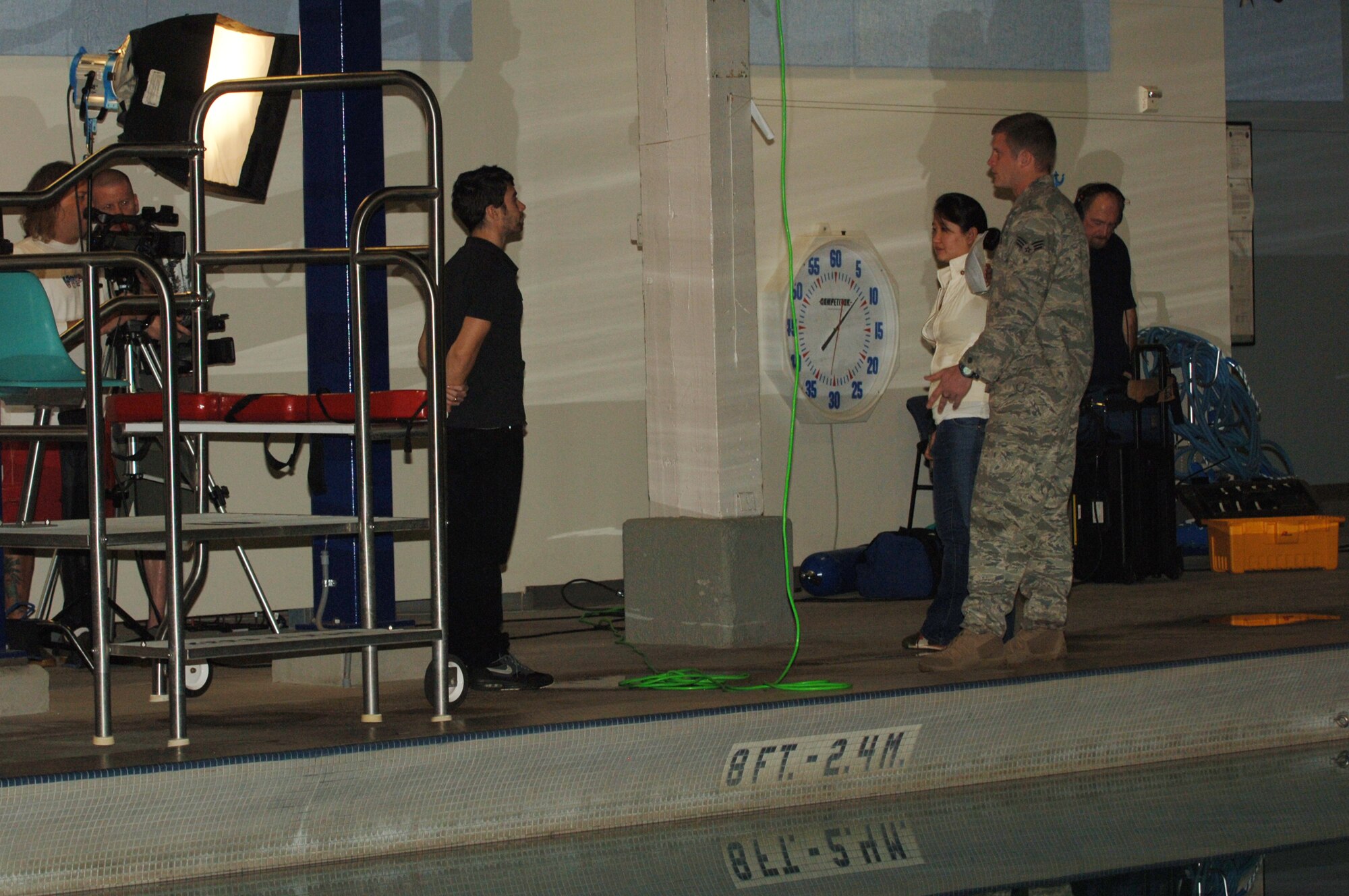 FAIRCHILD AIR FORCE BASE, Wash. – Senior Airman Ethan Jago, 66th Training Squadron SERE Specialist listens to instructions from the MTV crew before filming begins at the Aquatic Center Nov. 18. Airman Jago was chosen to narrate for the episode demonstrating the steps involved to egress from a submerged vehicle for the “How To Show” on MTV.com and MTV mobile. (U.S. Air Force photo / Senior Airman Jocelyn A. Ford)