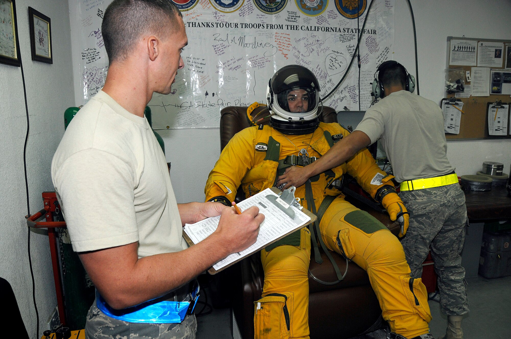 Senior Airman Allen Smith and Senior Airman David Sivixay test and verify Lt. Col. Brian Dickinson's full-pressure flight suit Nov. 14. Both are with the 99th Expeditionary Reconnaissance Squadron physiological support division at an air base in Southwest Asia. Colonel Dickinson is a U-2 Dragonlady pilot with the 99th and is responsible for gathering intelligence in the area of responsibility in support of operations Iraqi and Enduring Freedom. (U.S. Air Force photo/Tech. Sgt. Christopher A. Campbell)