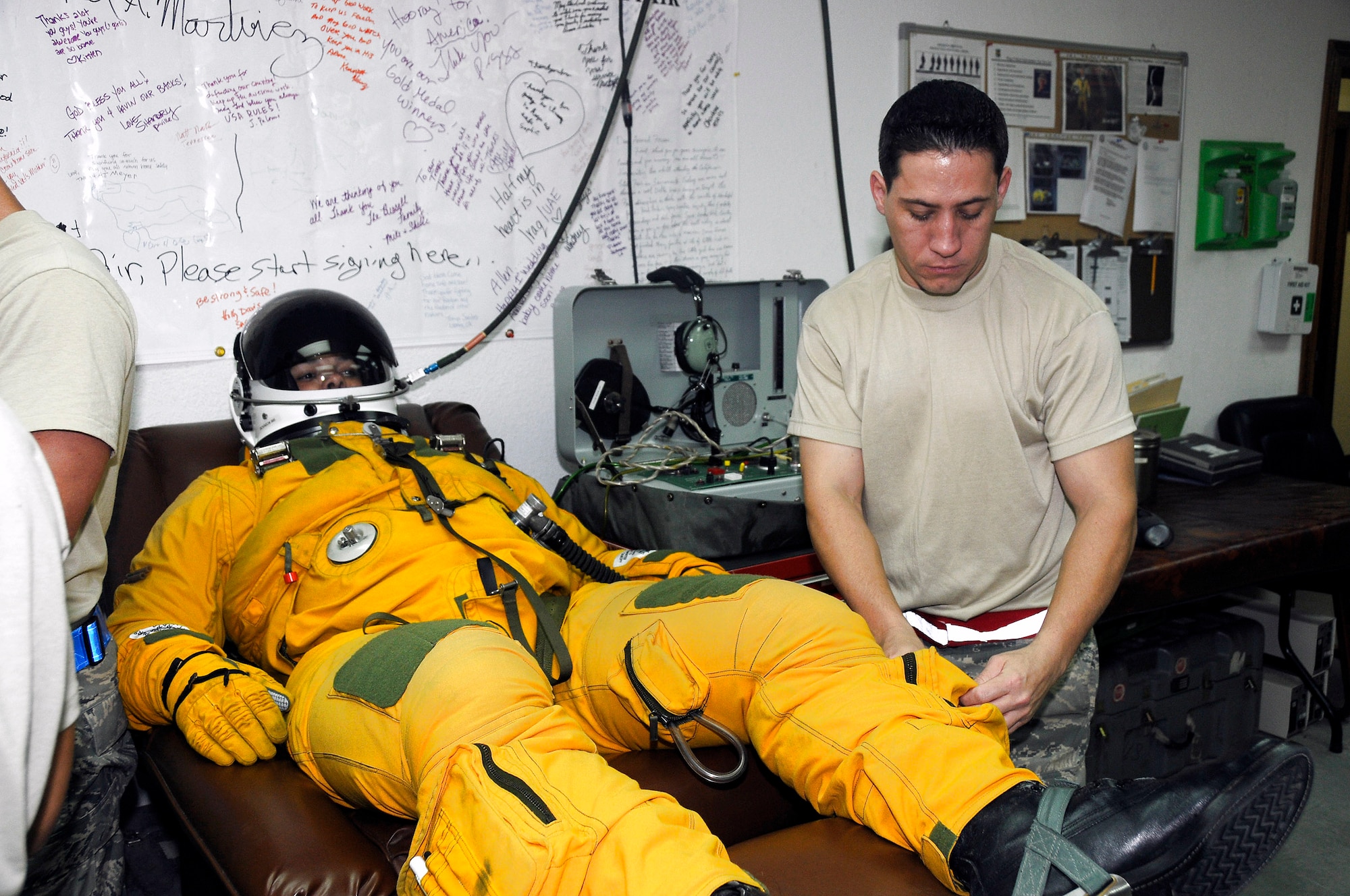 Lt. Col. Brian Dickinson receives a dose of oxygen while Tech. Sgt. Shawn Hansen performs a final inspection of his flight suit Nov. 14 prior to a high-altitude flight from an air base in Southwest Asia. Sergeant Hansen is with the 99th Expeditionary Reconnaissance Squadron Physiological Support Division. Colonel Dickenson is a U-2 Dragonlady pilot with the 99th ERS and is responsible for gathering intelligence in the area of responsibility in support of operations Iraqi and Enduring Freedom. (U.S. Air Force photo/Tech. Sgt. Christopher A. Campbell)