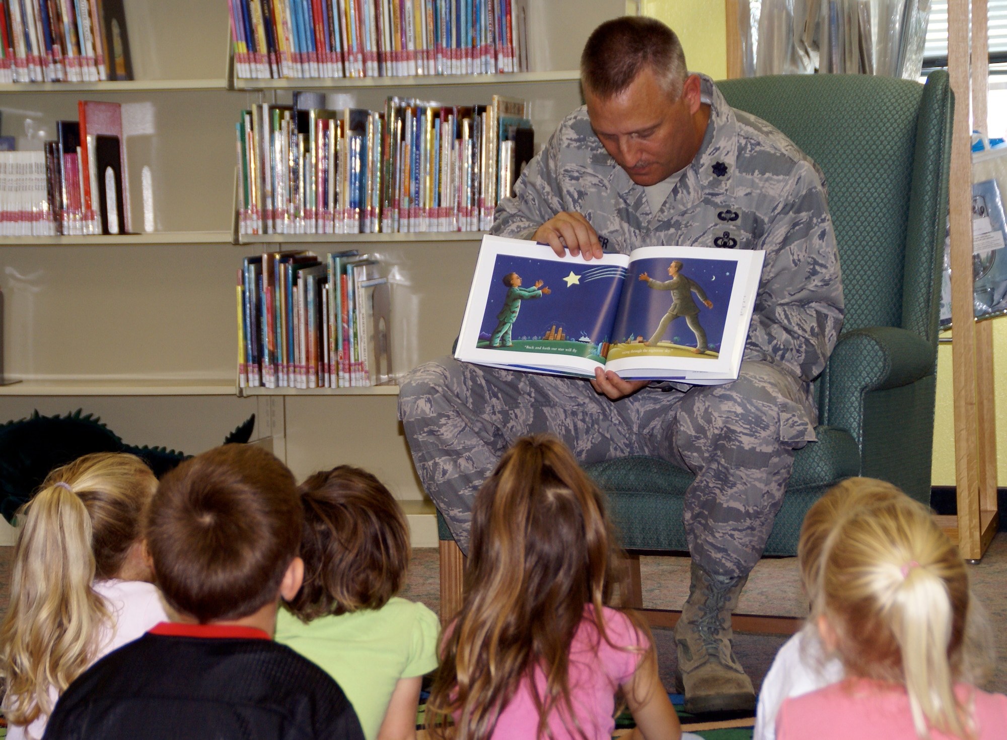EGLIN AIR FORCE BASE, Fla. -- Lt. Col. Christopher Wheeler, 96th Mission Suppot Group commander, reads to preschool children during Story Time, at the Eglin Base Library Nov. 13. Story Time is a program designed to encourage children to read. The library has implemented other programs and expanded new sections dedicated to deployed Airmen and their family members that help relieve some of the stress that accompany deployment. (US Air Force photo/ Joshua Bausch)                