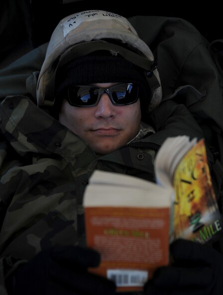 MOODY AIR FORCE BASE, Ga. -- Staff Sgt. Ryan O'neill, 23rd Aircraft Maintenance Squadron weapons crew chief, reads a book in a simulated bunker during an operational exercise here Nov. 17. The purpose of the exercise was to test the wing's ability to survive and operate in a conventional environment where the use of chemical and biological agents may be used. (U.S. Air Force photo by Senior Airman Gina Chiaverotti)